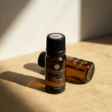Charisma Candles rose fragrance oil bottle with elegant packaging, showcasing the floral scent and rich amber color.