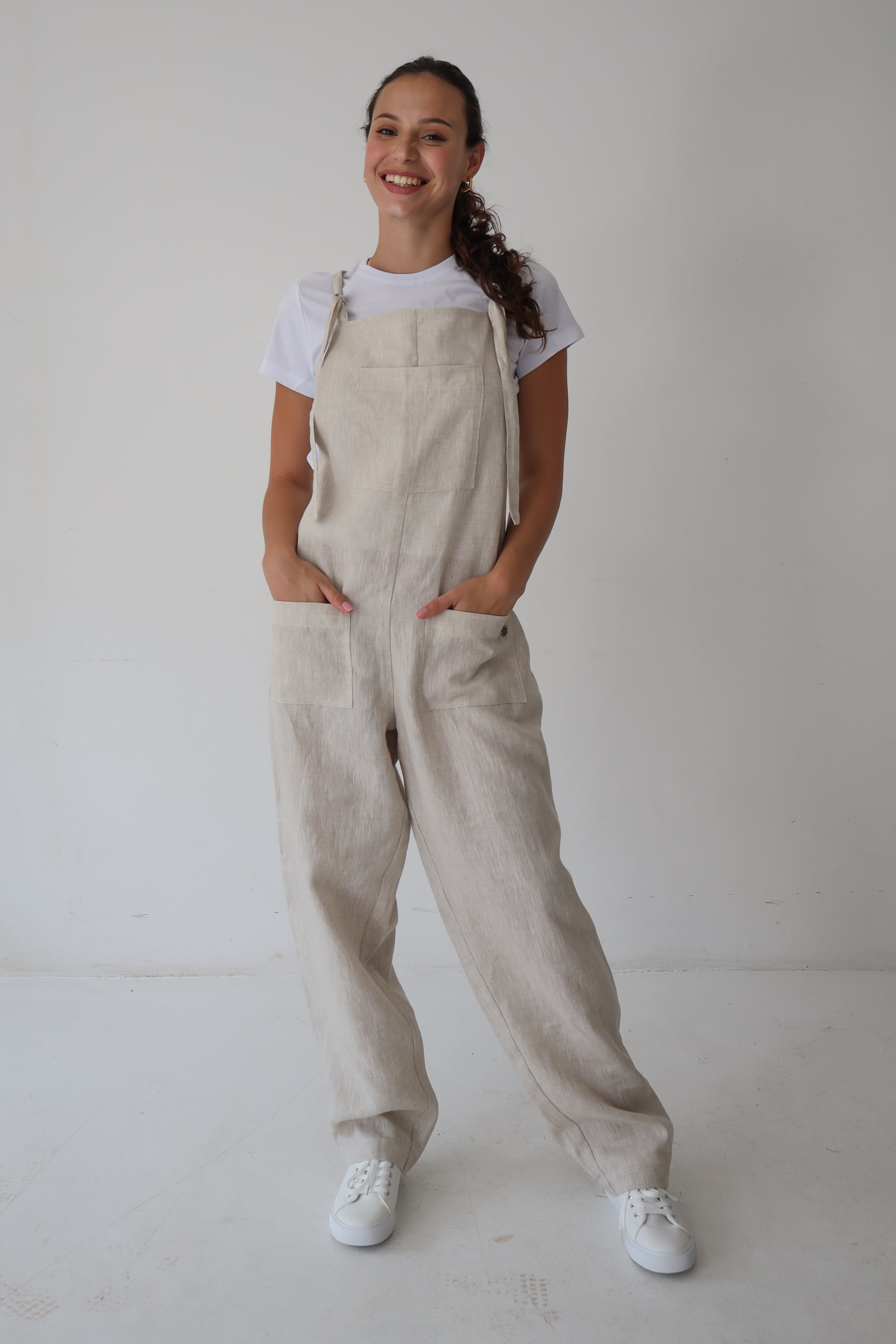 Di Ti Amo Clothing Nix Dungaree Long in natural fabric, casual style, displayed hanging on a wooden background.