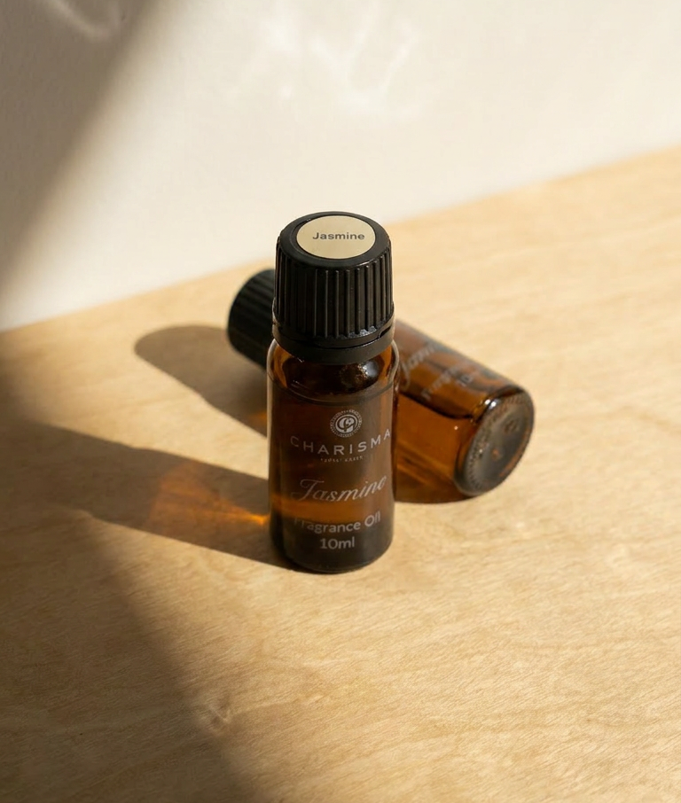 Charisma Candles jasmine fragrance oil in a clear glass bottle with a black cap, suitable for aromatherapy and home scents.