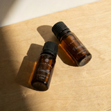 Charisma Candles vanilla fragrance oil in a clear glass bottle with a black cap, ready for use in aromatherapy or candle making.