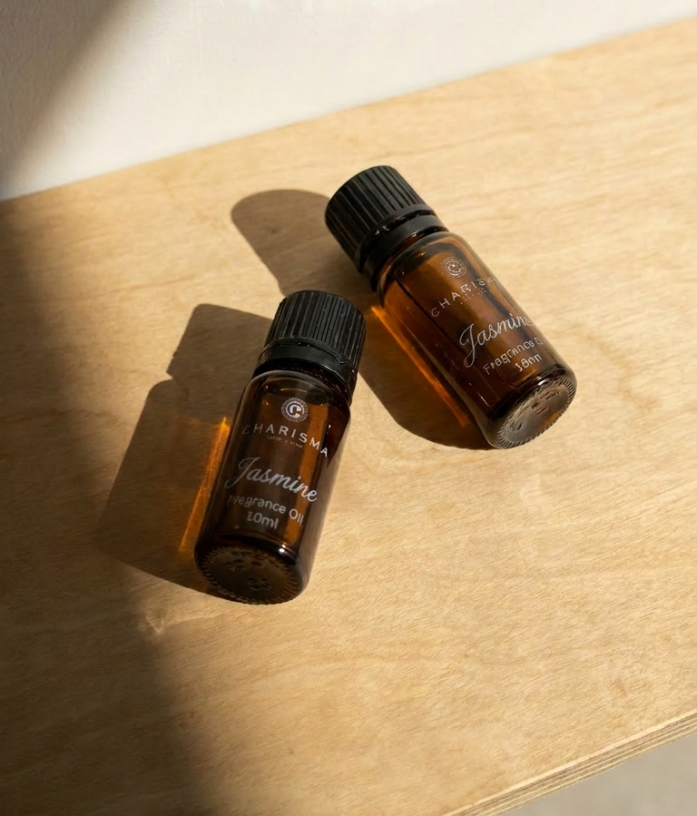 Charisma Candles Jasmine fragrance oil in a clear glass bottle with a black cap, showcasing the aromatic floral scent.