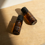 Charisma Candles Jasmine fragrance oil in a clear glass bottle with a black cap, showcasing the aromatic floral scent.