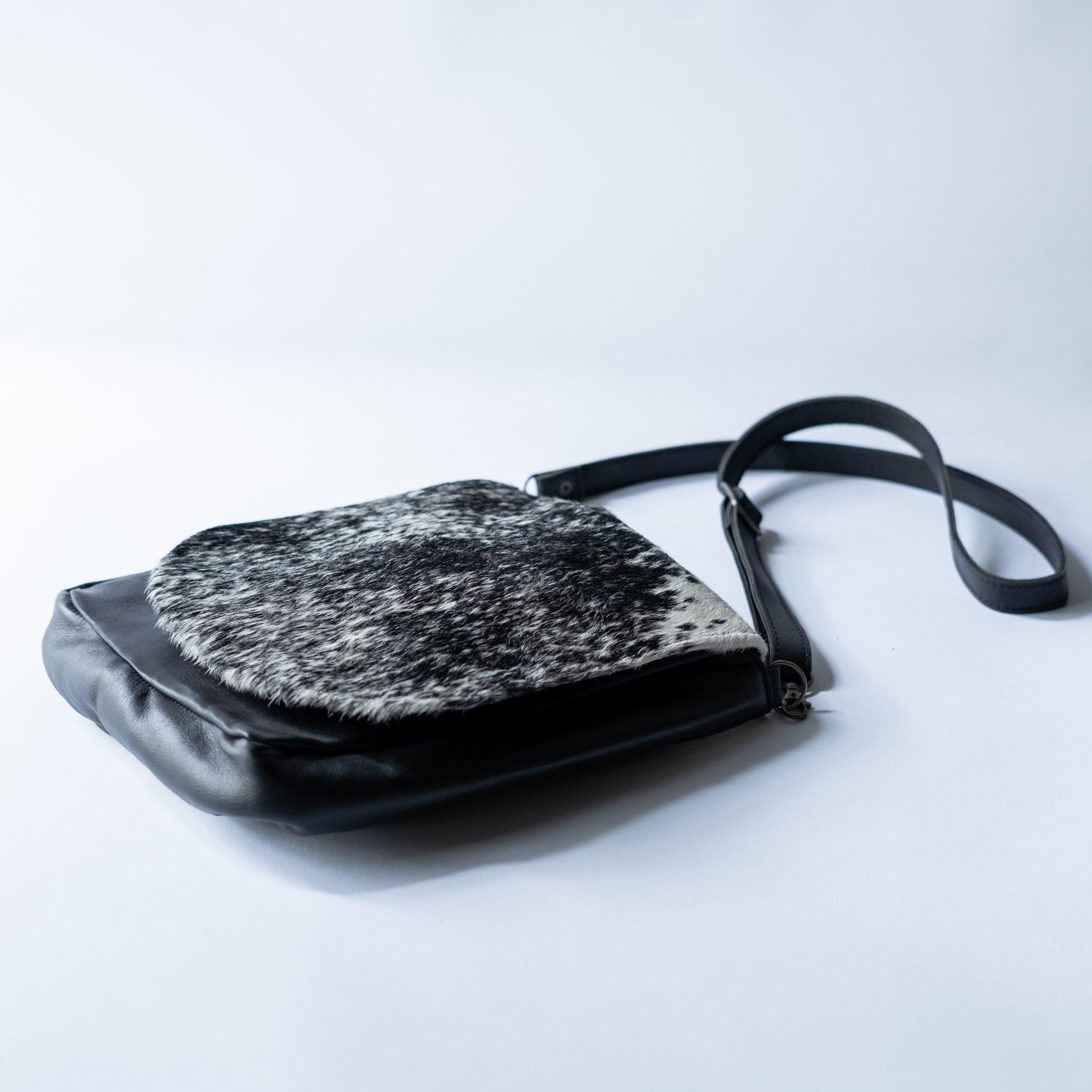 Black and white Moo Sophie sling bag by MOO, stylish consignment accessory with sleek design and adjustable strap.