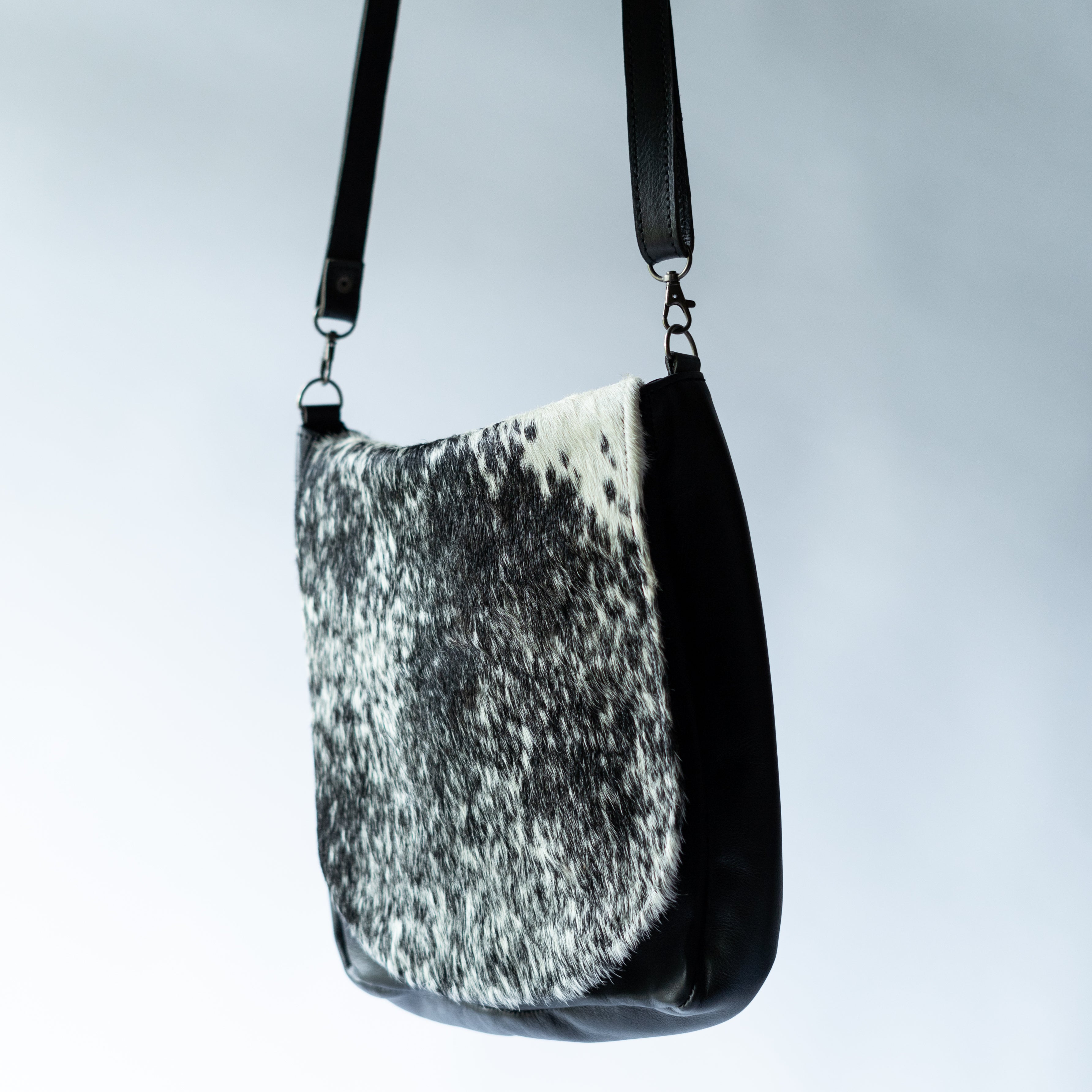 Black and white Moo Sophie Sling Bag by MOO with sleek design, shown on a model, perfect for stylish everyday use.