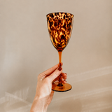Tortoiseshell wine glass from Tusker Trading with elegant shape and vibrant tortoiseshell pattern, perfect for wine enjoyment.