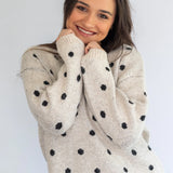 Grey polka knit jersey by Coco & Salt, showing a close-up of the soft, textured fabric and polka dot pattern.