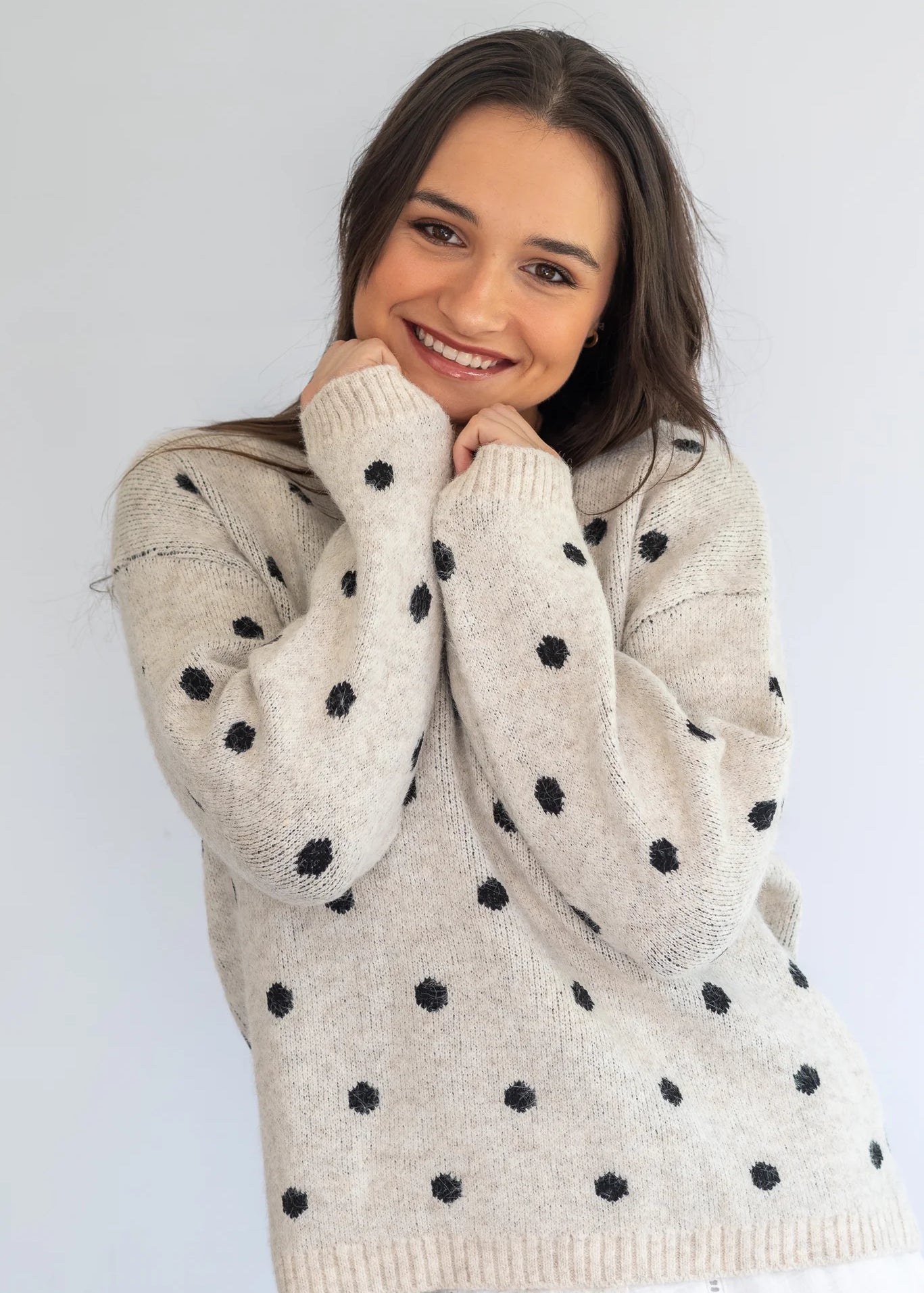 Grey polka knit jersey by Coco & Salt, showing a close-up of the soft, textured fabric and polka dot pattern.