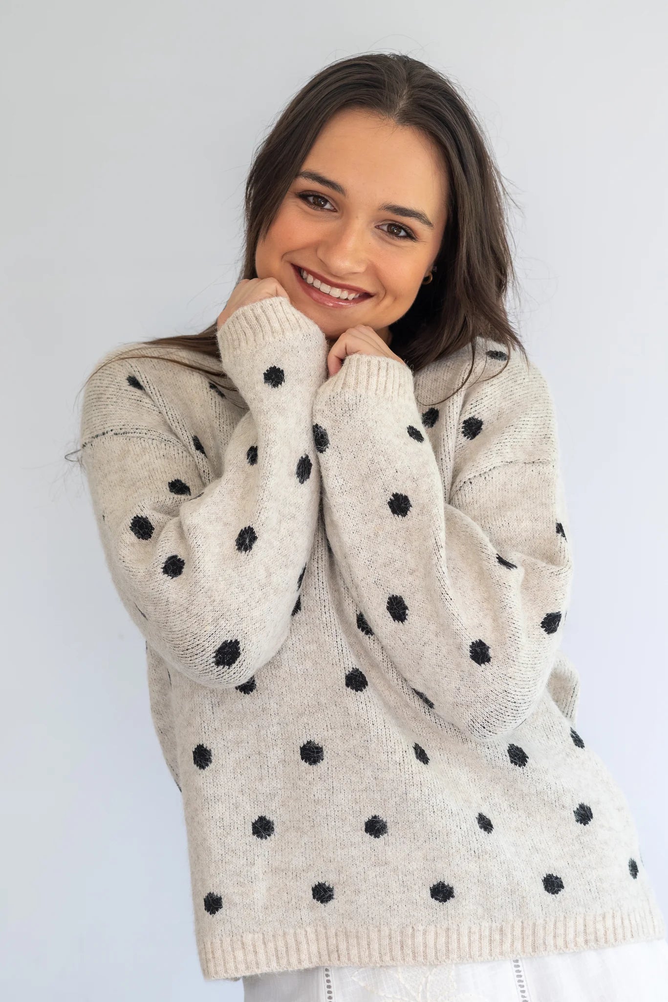 Grey polka knit jersey by Coco & Salt, showing a close-up of the soft, textured fabric and polka dot pattern.