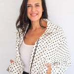 Coco & Salt Ella Polka Jacket hanging on a rack, featuring a stylish polka dot pattern and tailored fit.
