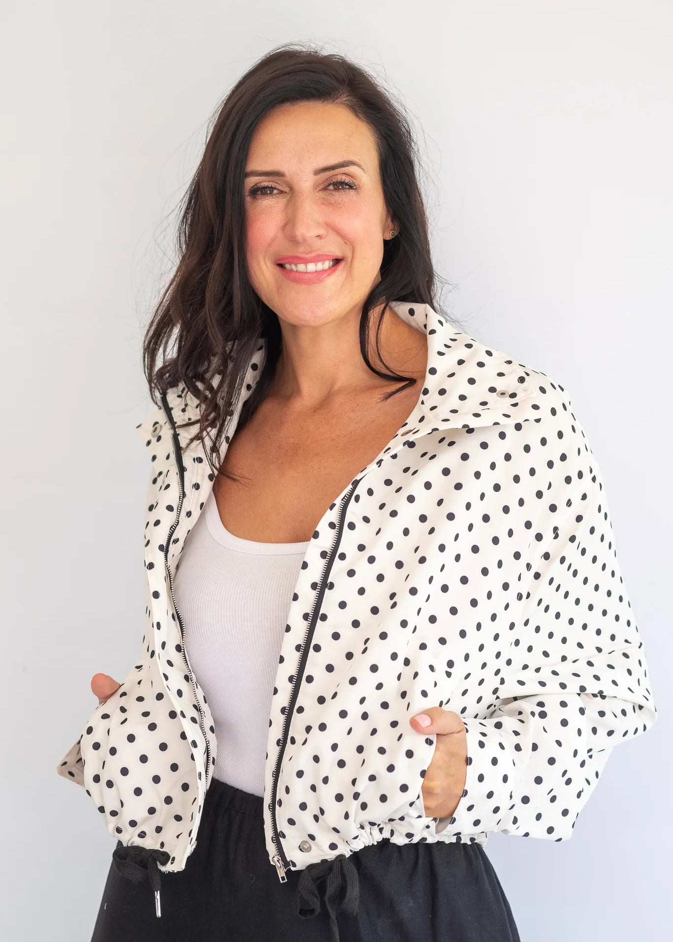Coco & Salt Ella Polka Jacket hanging on a rack, featuring a stylish polka dot pattern and tailored fit.