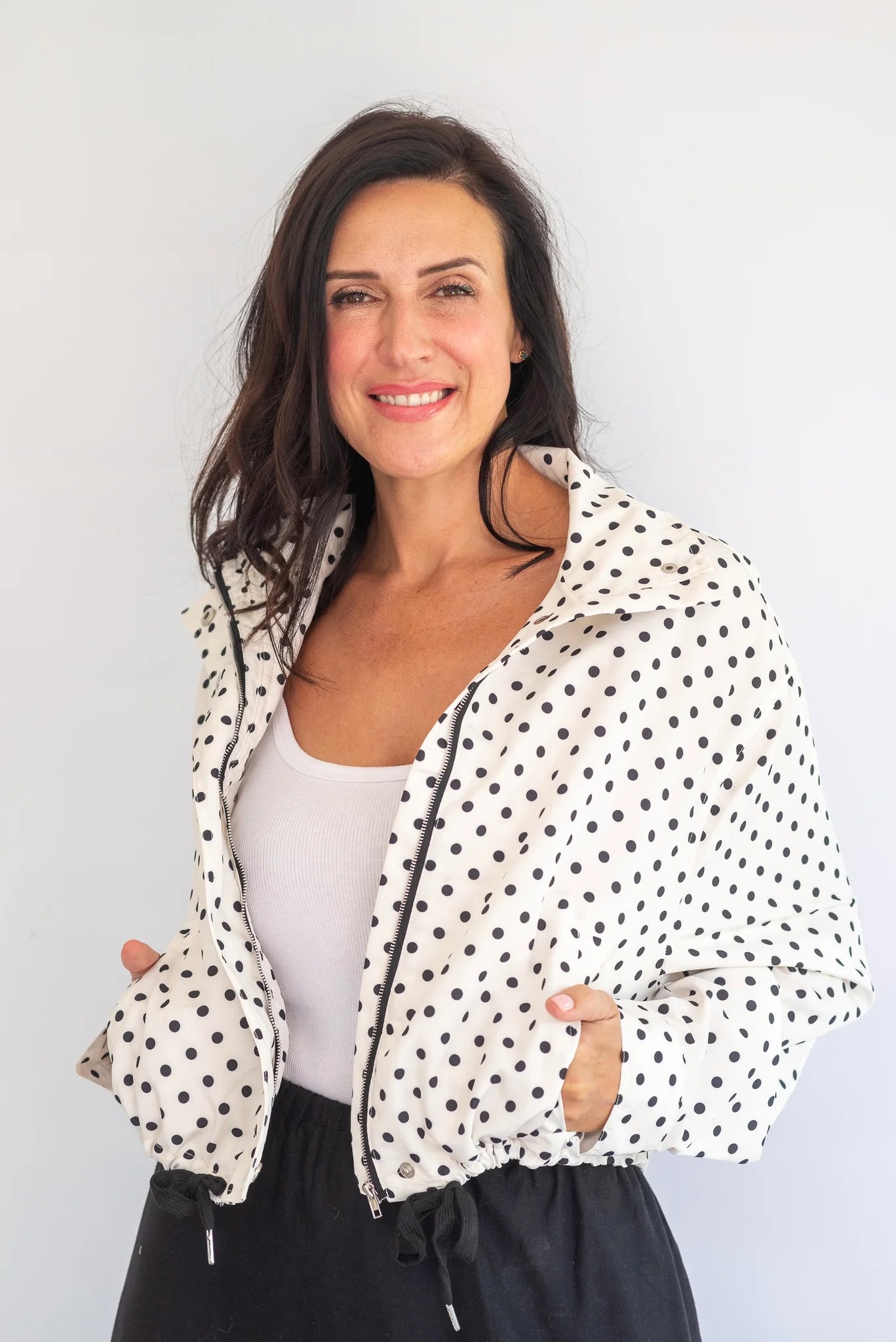 Coco & Salt Ella Polka Jacket hanging on a rack, featuring a stylish polka dot pattern and tailored fit.