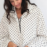 Coco & Salt Ella Jacket in Polka print displayed on a hanger, showcasing its stylish design and fabric details.