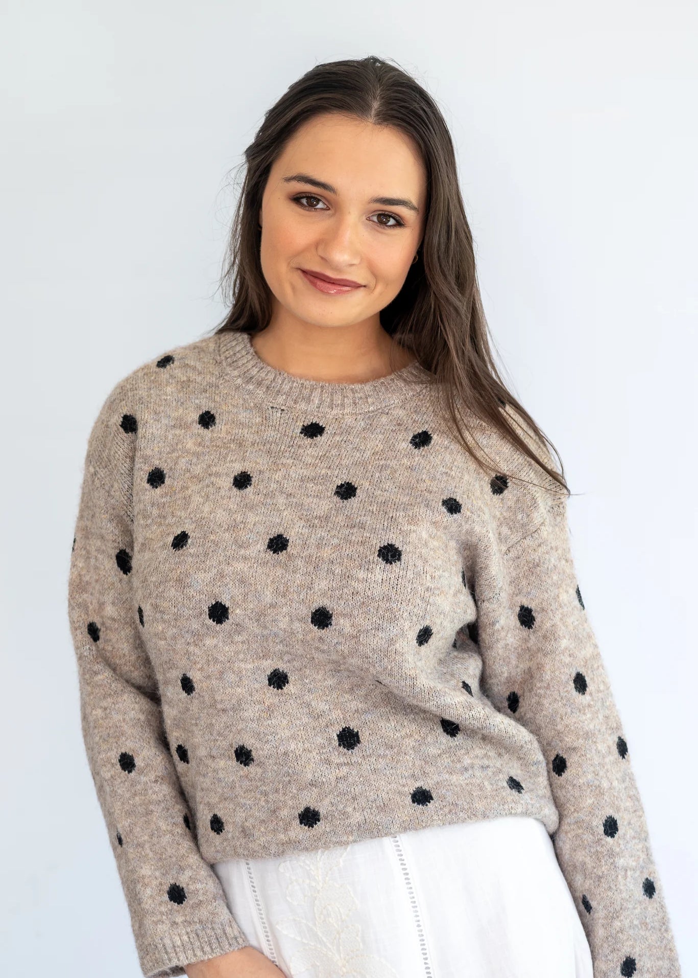 Stone polka knit jersey by Coco & Salt, displayed flat, showcasing its soft fabric and playful polka dot pattern.
