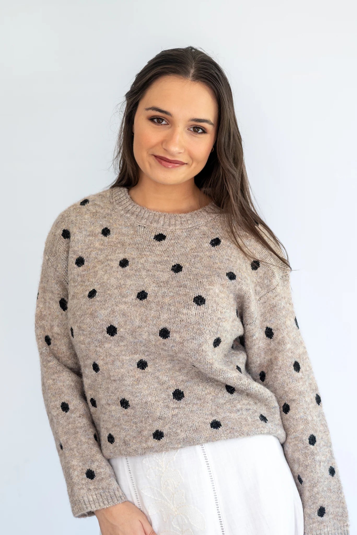 Stone polka knit jersey by Coco & Salt, displayed flat, showcasing its soft fabric and playful polka dot pattern.