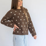 Polka Knit Jersey in Choc by Coco & Salt, displayed on a hanger with a soft knit texture and polka dot pattern.
