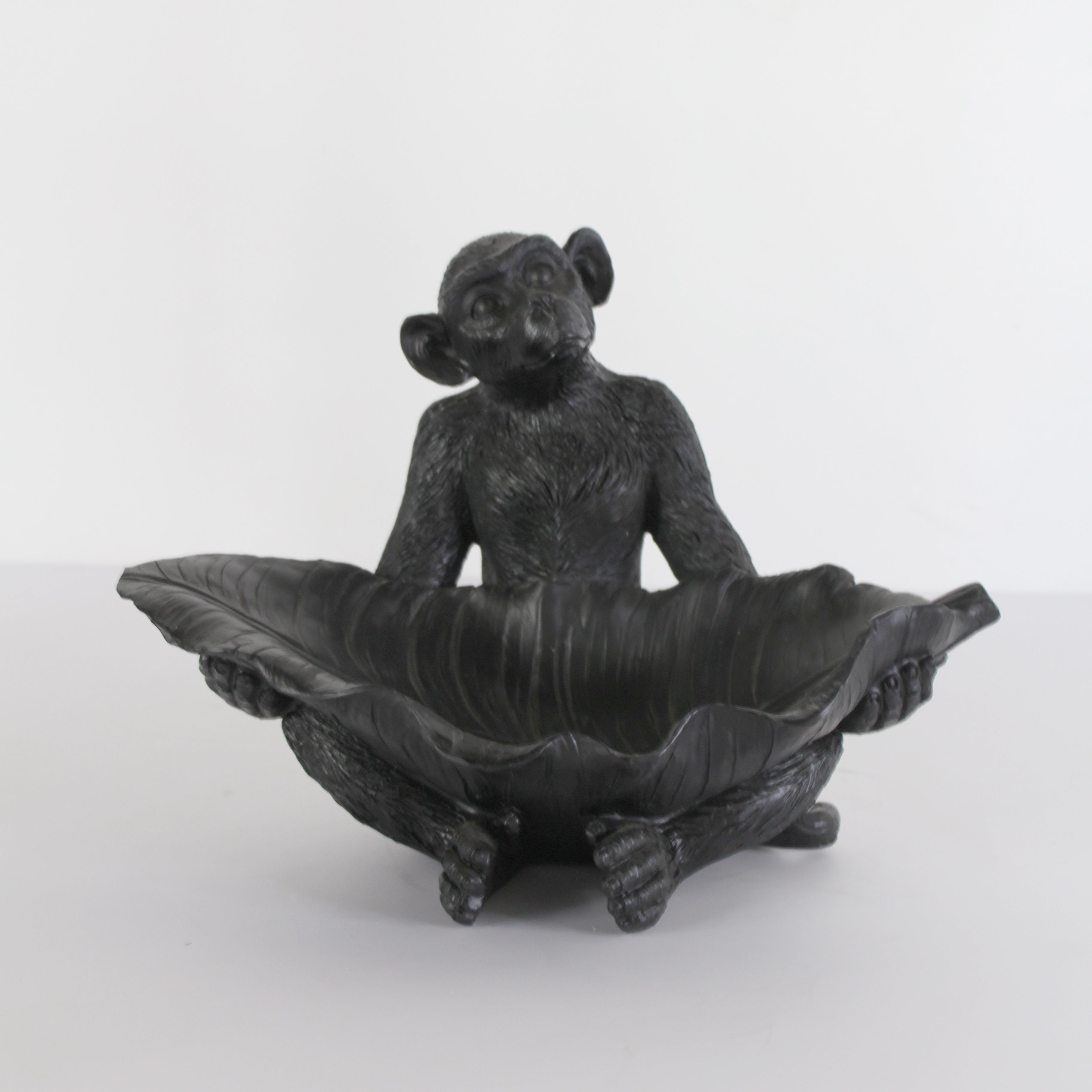 Black resin monkey with leaf sculpture by Spaces & Places, detailed account figure on a neutral background.