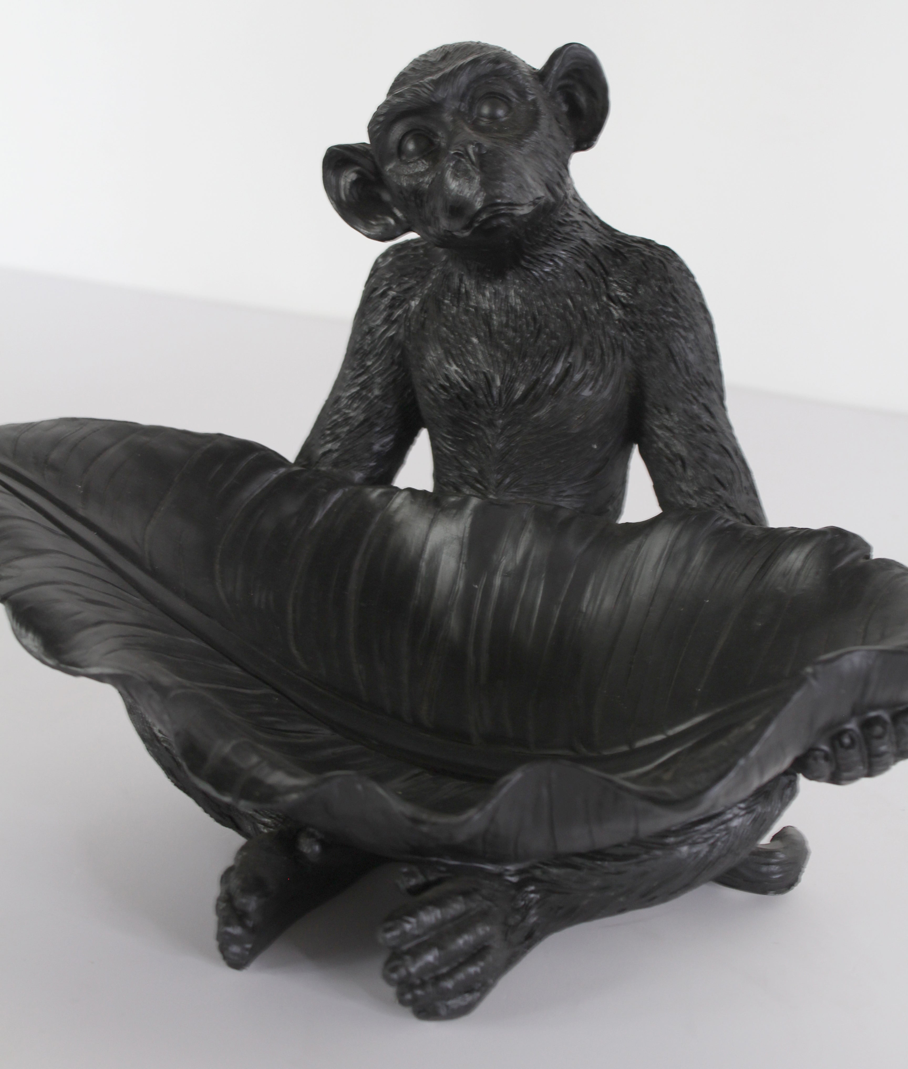 Black resin monkey figurine with leaf detail, decorative animal sculpture by Spaces & Places.