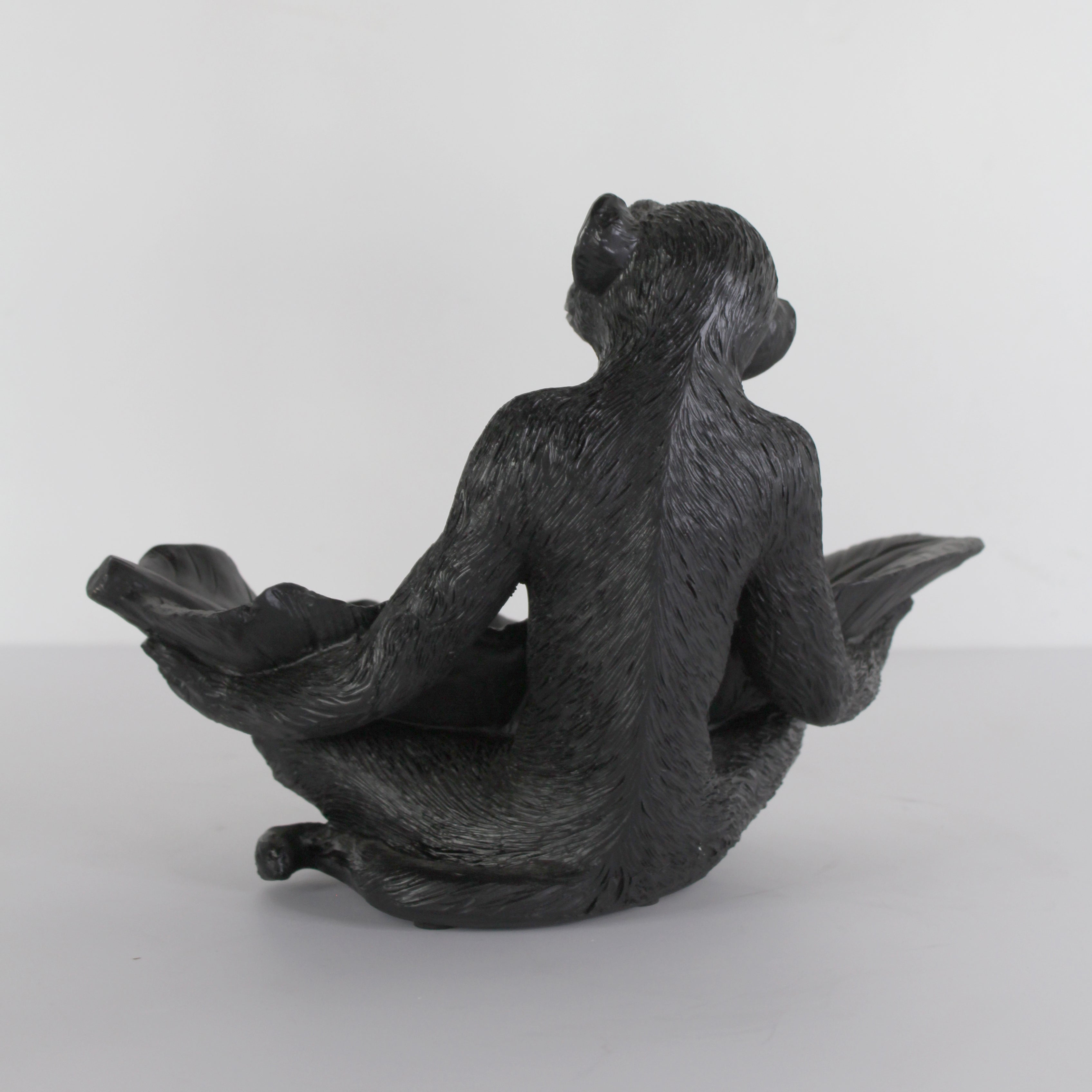 Black resin monkey with leaf sculpture from Spaces & Places, detailed textured account figure on a neutral background.