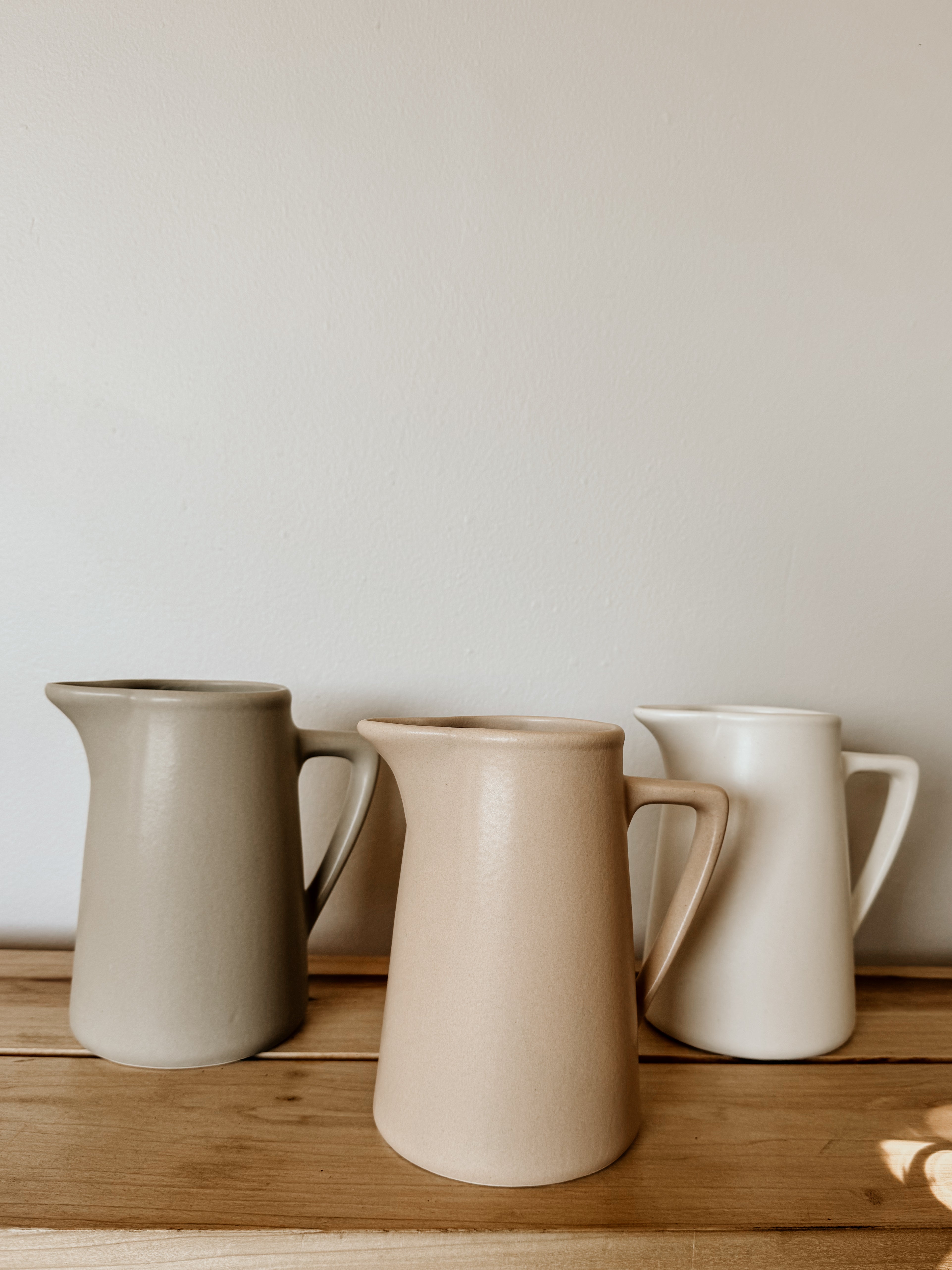 Raw clay milk jug by Pret-A-Pot, handcrafted ceramic cod-shaped pitcher for milk or liquids, with a rustic, artisanal finish.