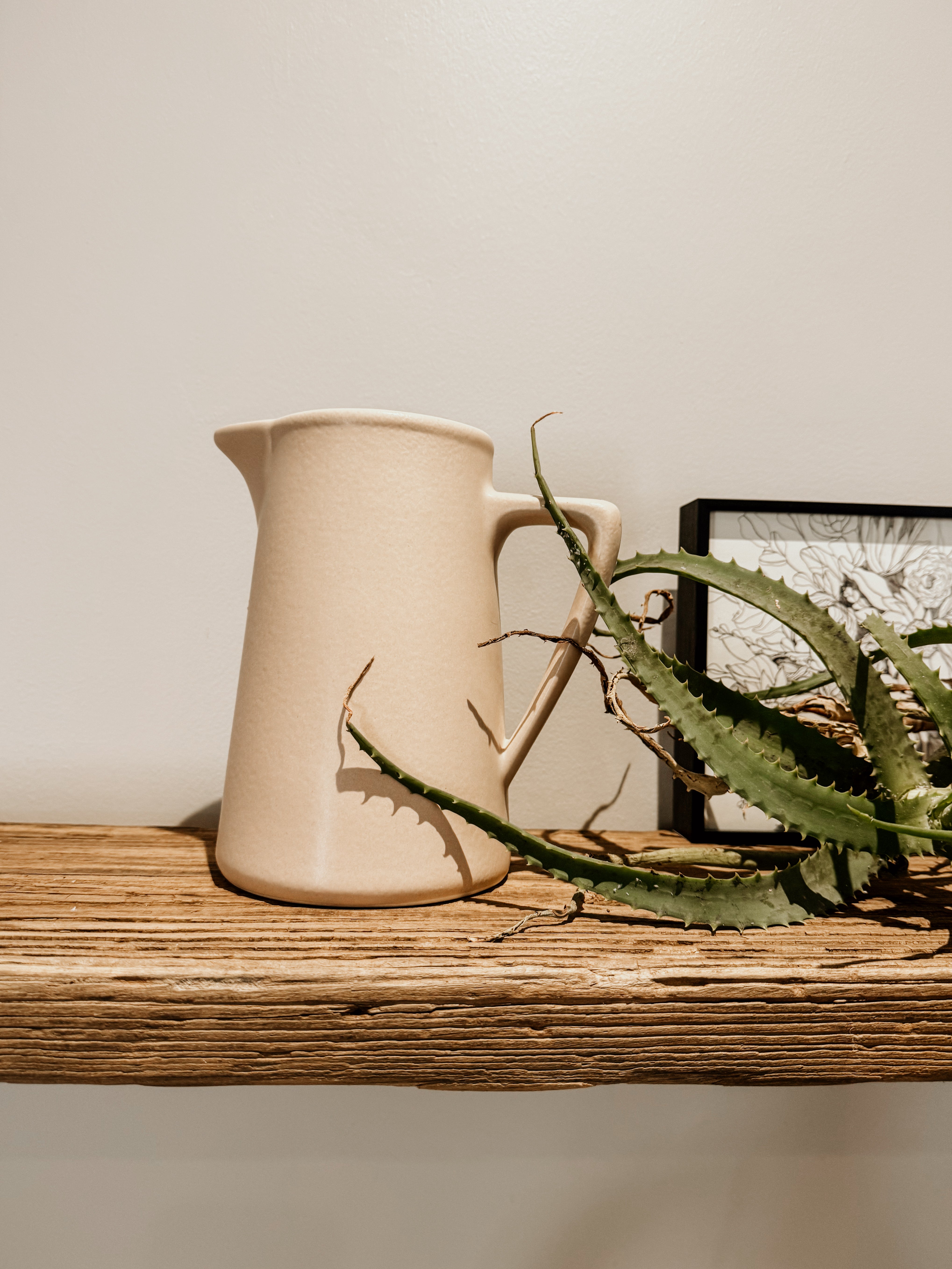 Raw clay milk jug by Pret-A-Pot featuring a traditional ceramic design with a handle and spout for pouring milk.