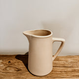 Raw clay milk jug by Pret-A-Pot, cod type, featuring a rustic, handcrafted design with a narrow spout and rounded handle.