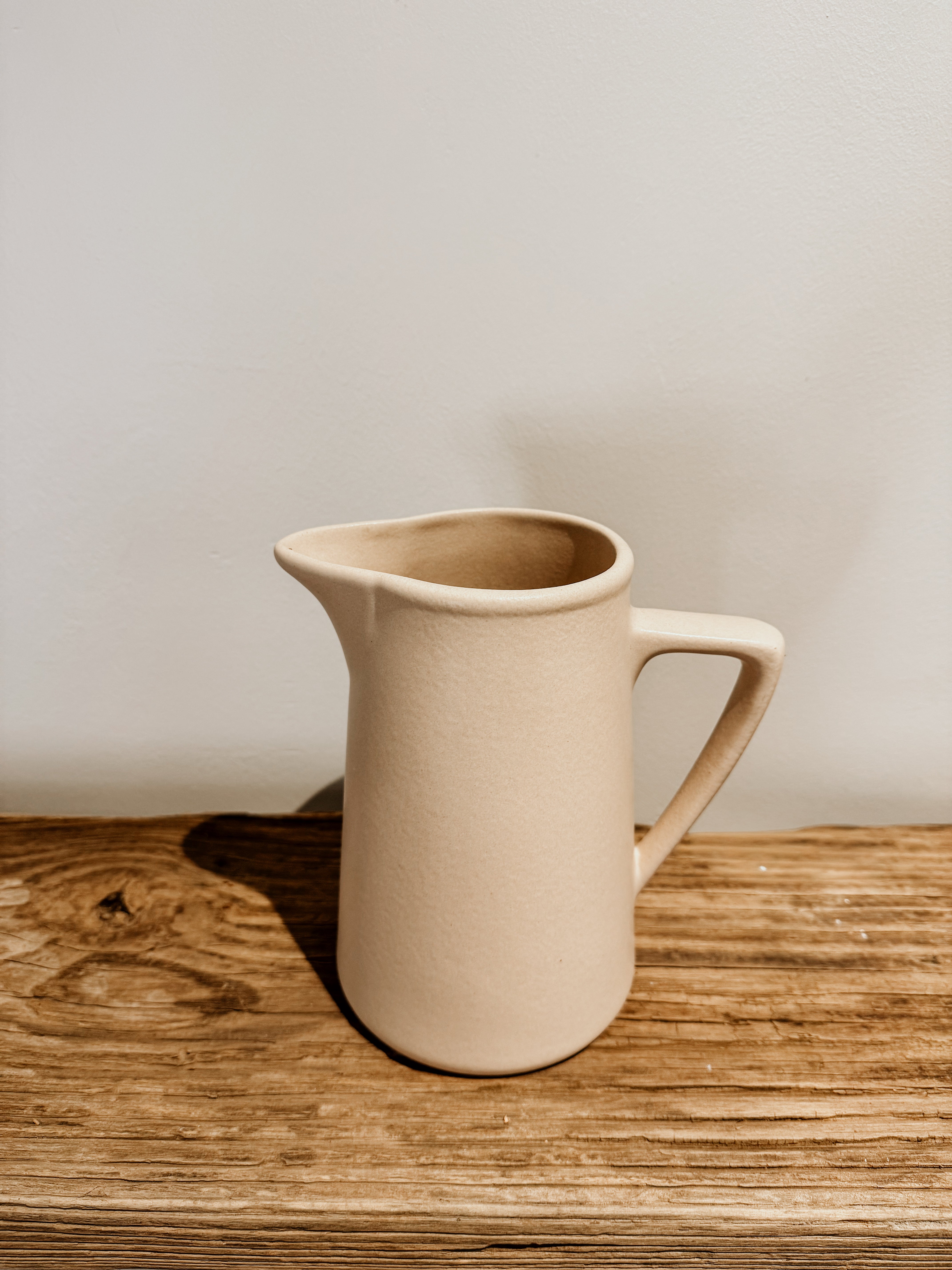 Raw clay milk jug by Pret-A-Pot, cod type, featuring a rustic, handcrafted design with a narrow spout and rounded handle.