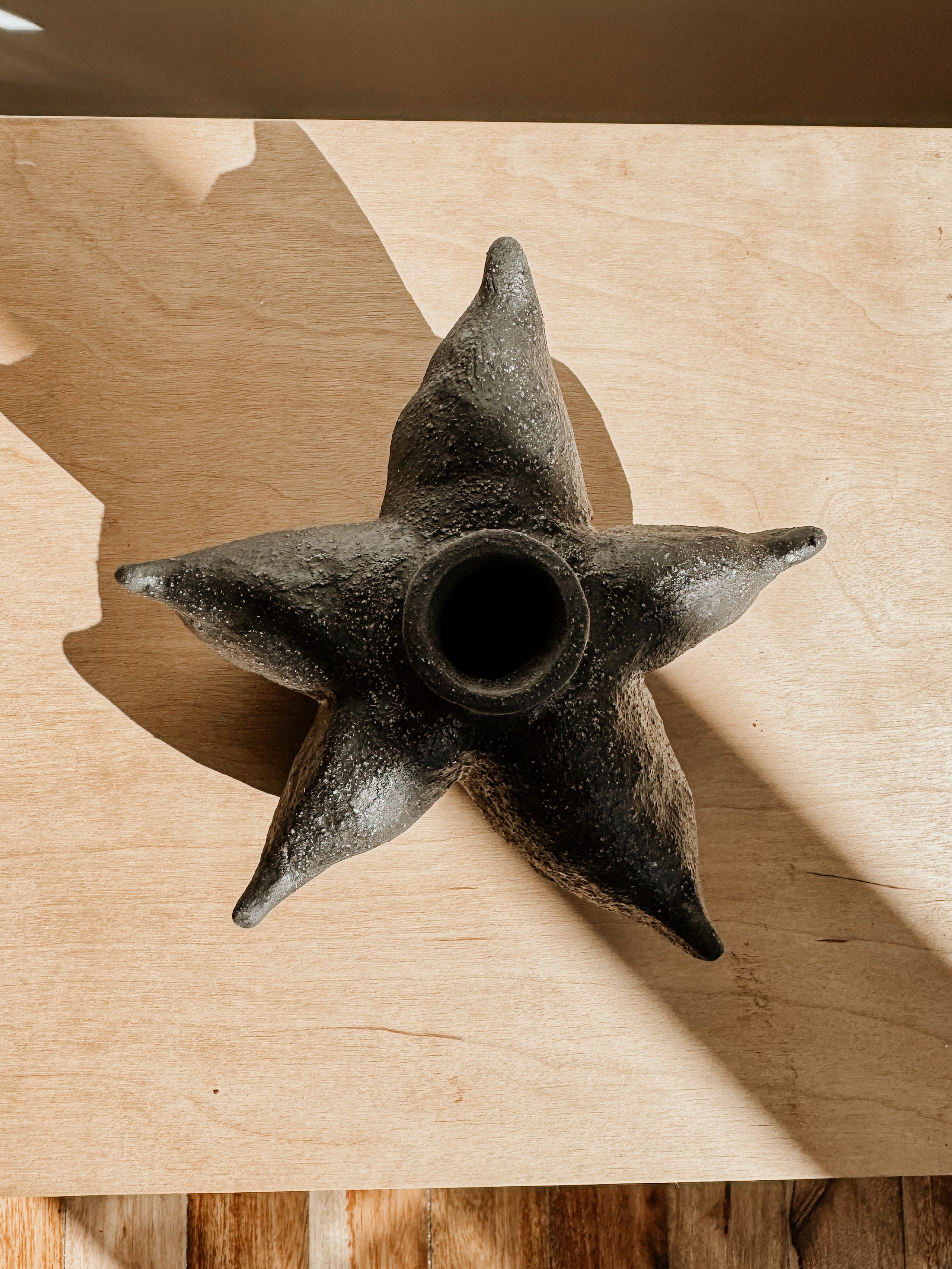 Black Anise Vessel by Delphine, a stylish ceramic piece with a smooth, matte finish, displayed on a neutral background.