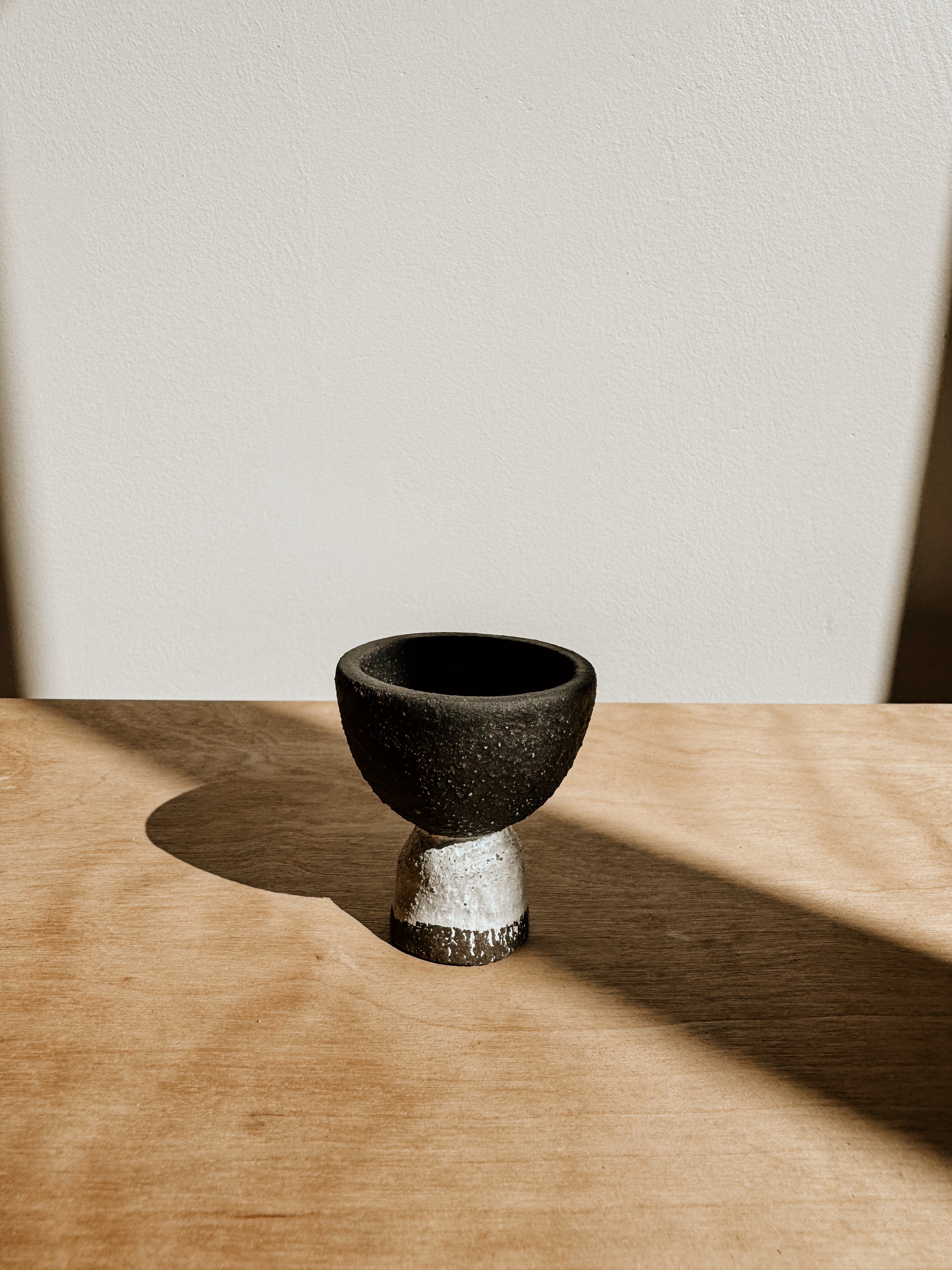 Egg cup from Delphine in matte black and white, featuring a sleek, minimalist design for stylish breakfast presentation.