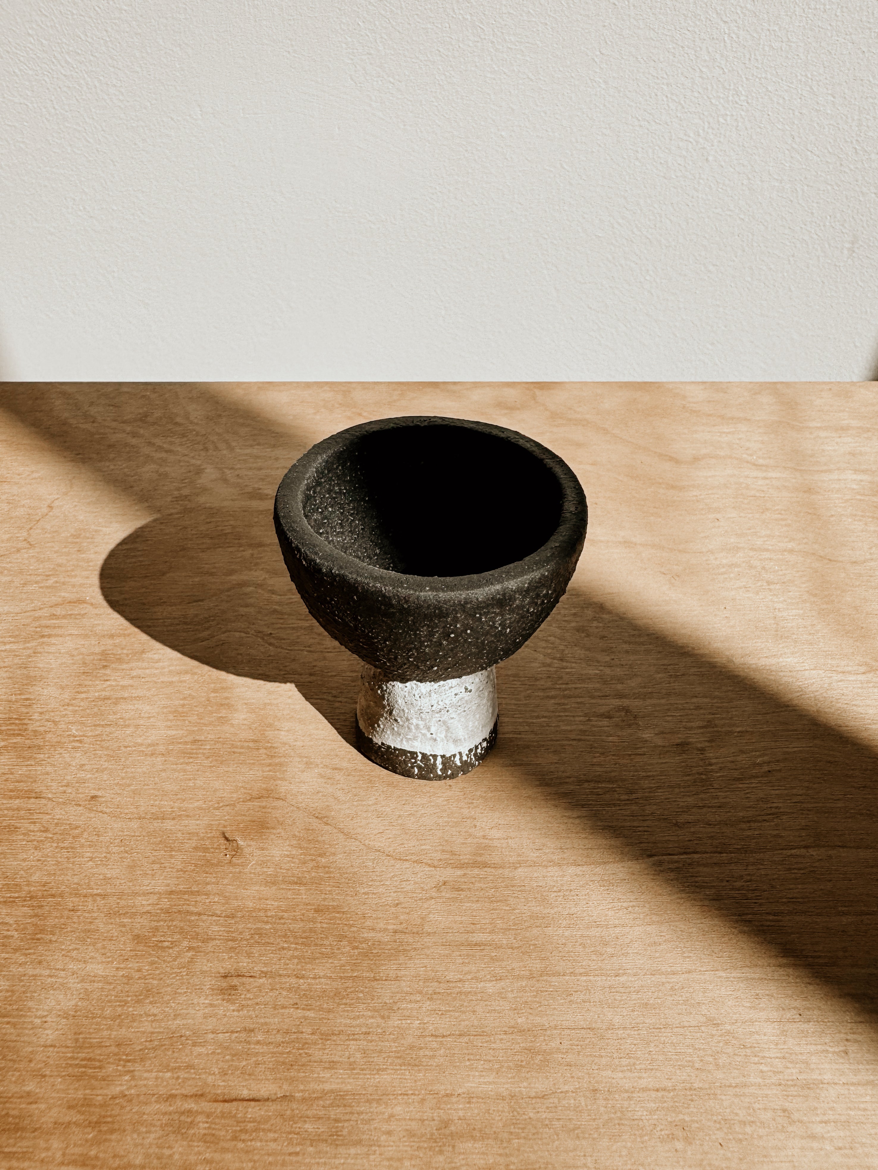 Delphine matte black and white egg cup on a white surface, stylish and modern kitchen accessory.