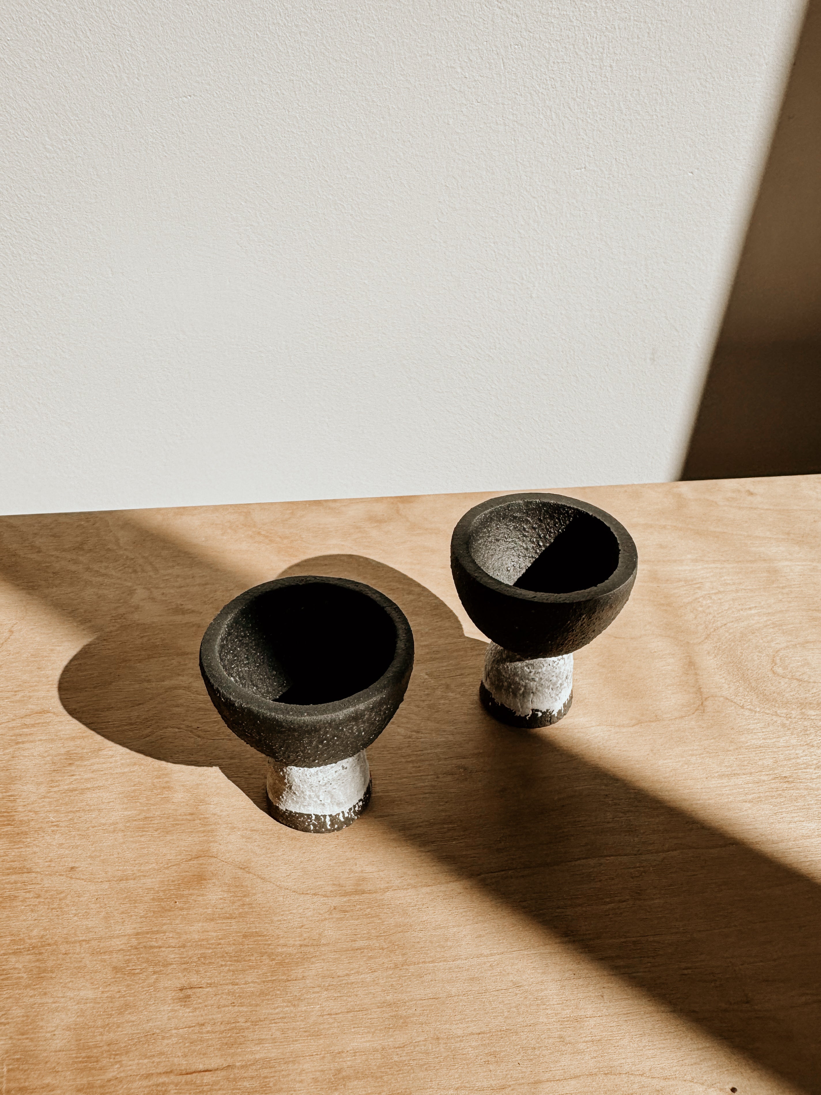 Delphine matte black and white egg cup on a white surface, stylish and modern kitchen accessory.