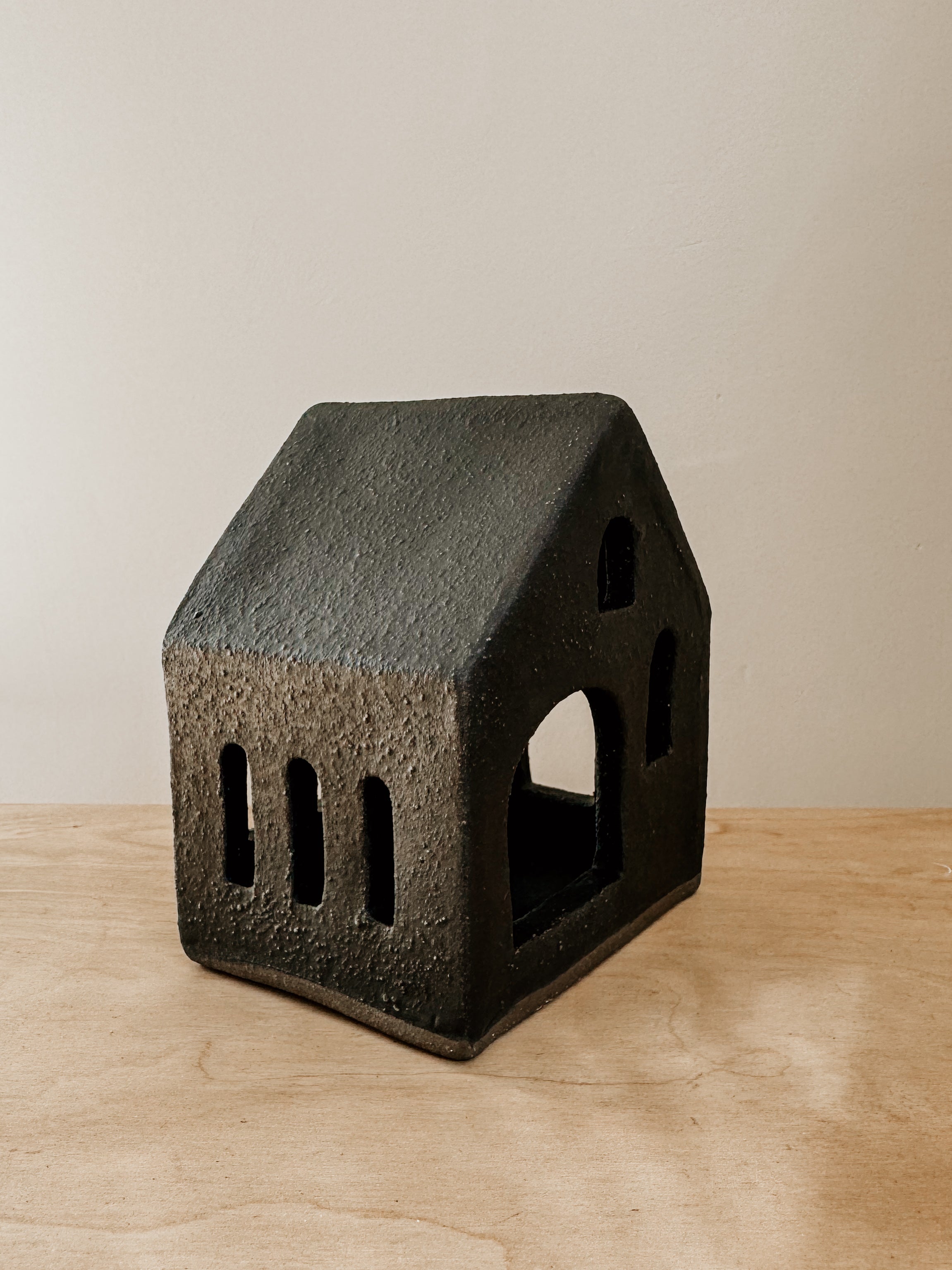 Small black tea light house candle holder by Delphine, featuring a cozy house design for ambient lighting.