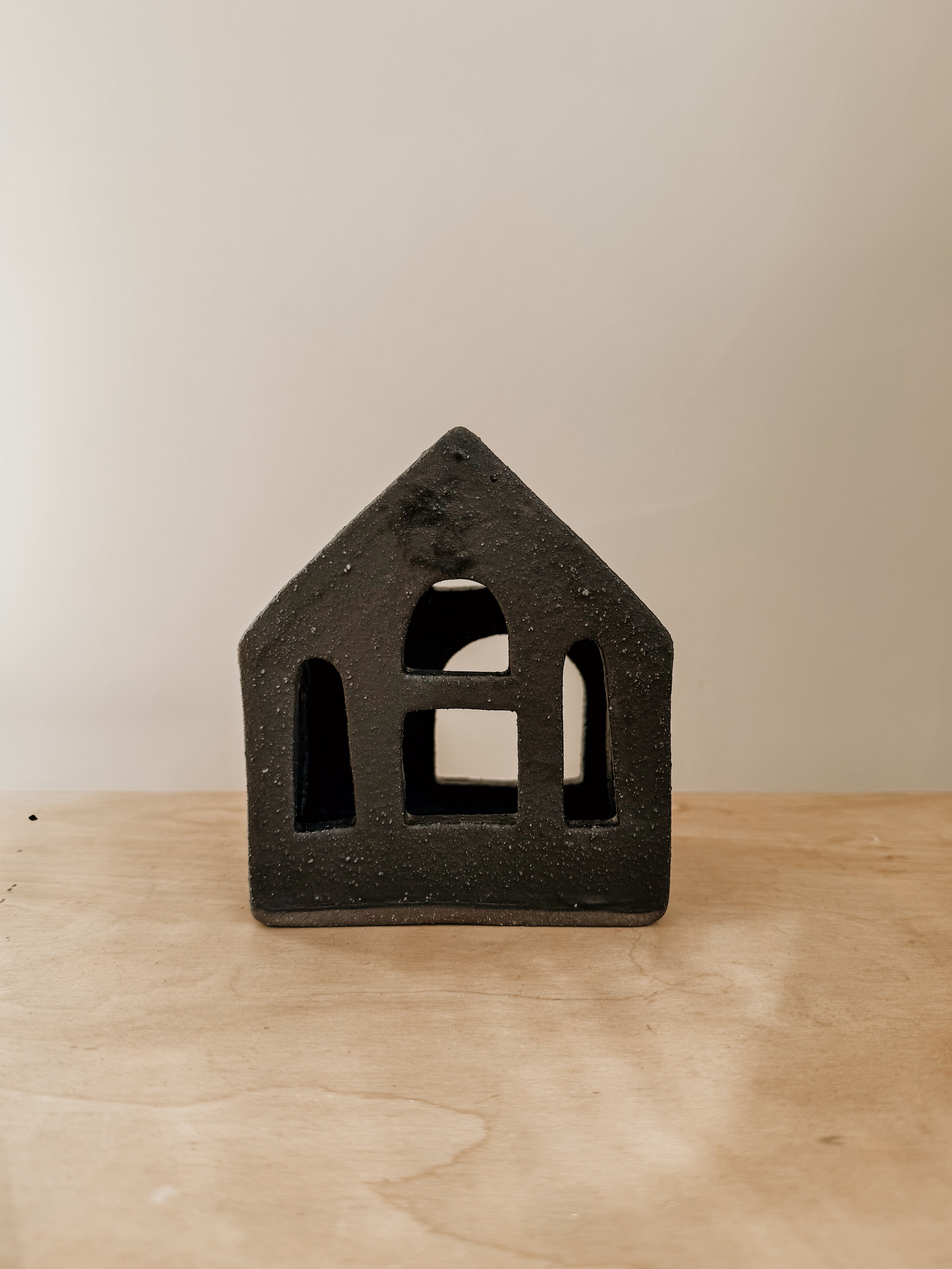 Black small tea light house by Delphine, decorative candle holder with a charming house design for ambient lighting.