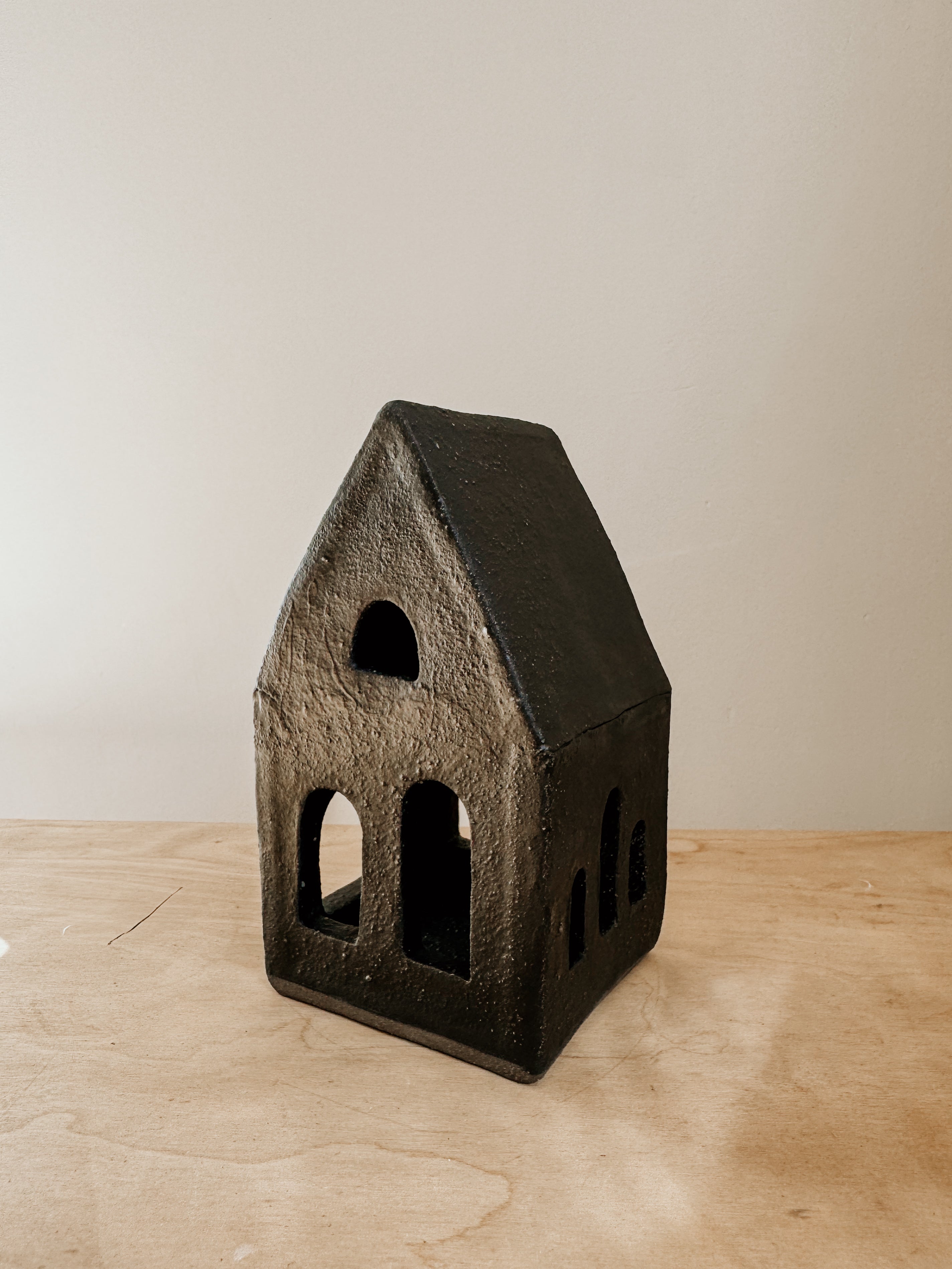 Large black tea light house candle holder by Delphine, featuring a cozy house design for decorative lighting.