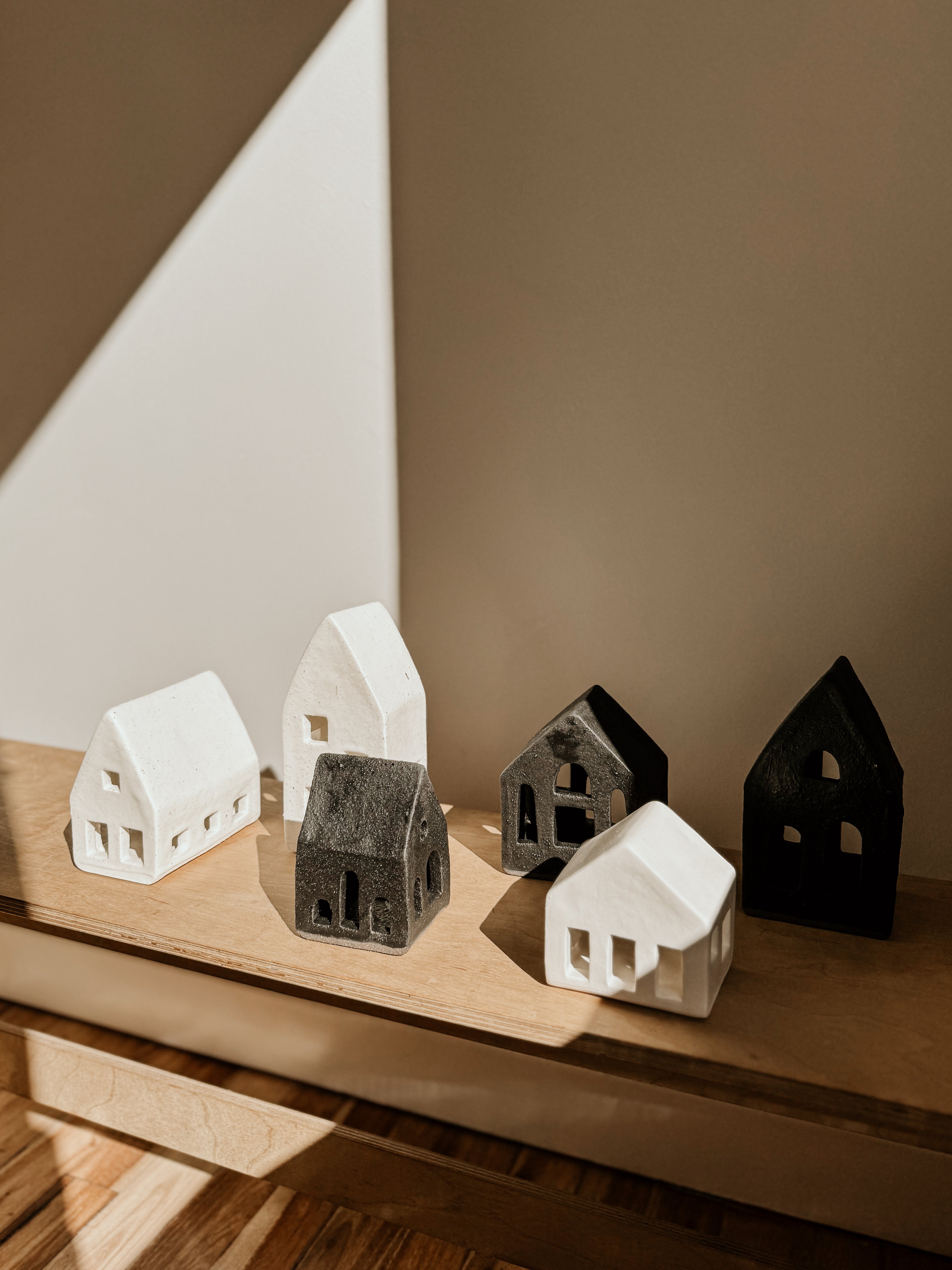White small tea light house candle holder by Delphine, decorative ceramic piece for cozy ambiance.