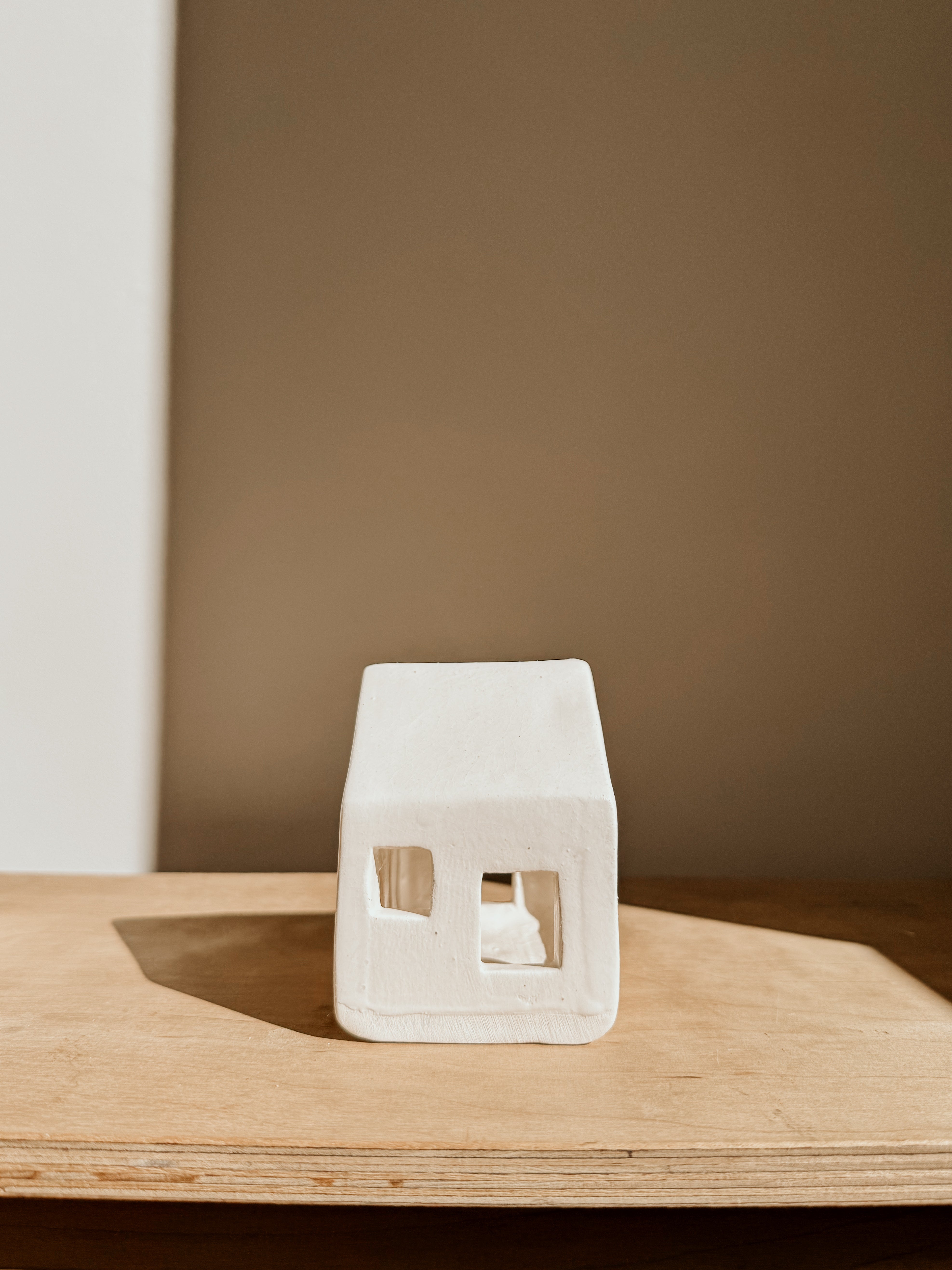 White small tea light house candle holder by Delphine, decorative ceramic piece for cozy ambiance, shown in image IMG_5771.jpg.