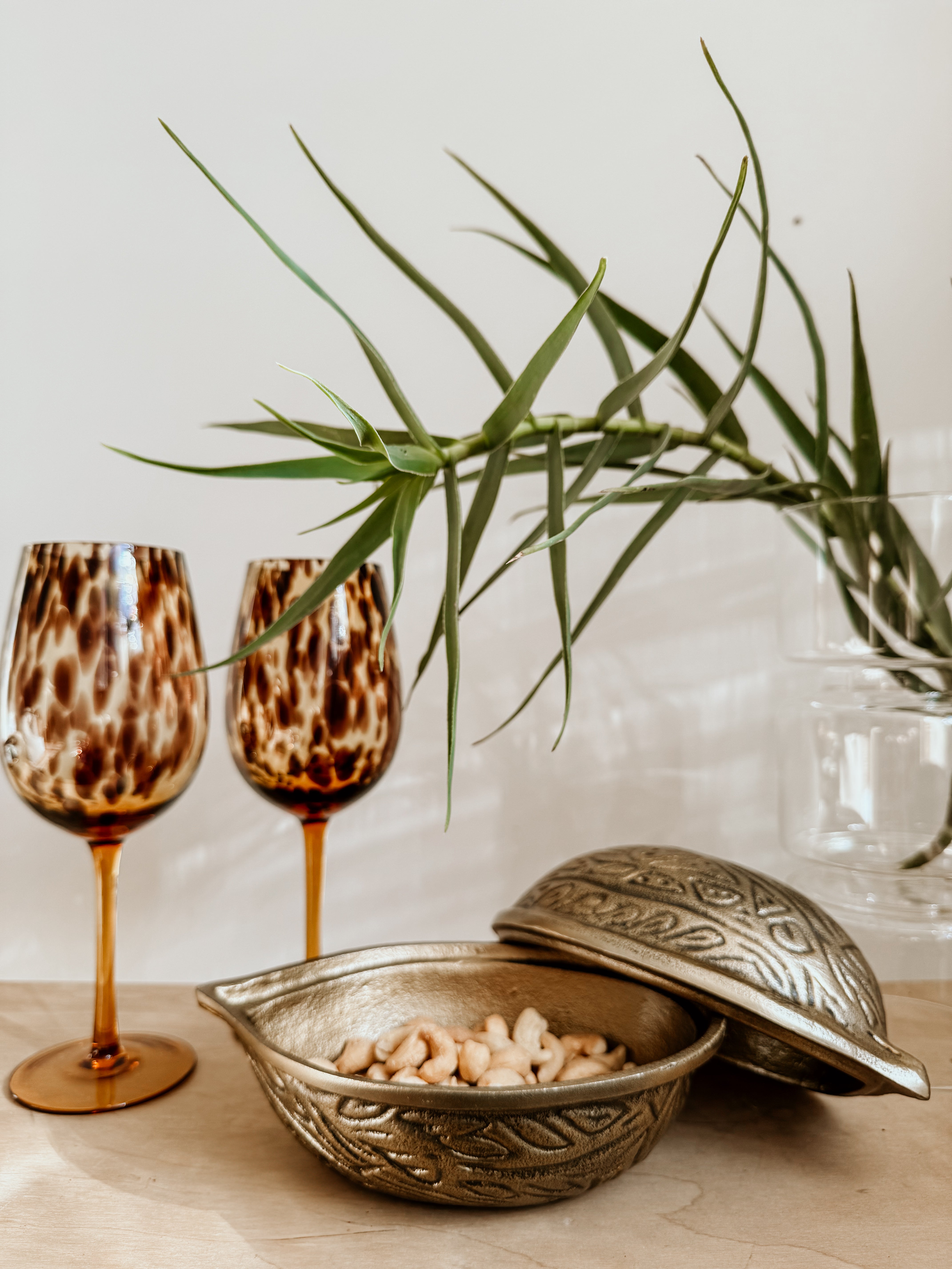 Tortoiseshell wine glass from Tusker Trading, elegant with a clear glass bowl and tortoiseshell-patterned stem for sophisticated sipping.