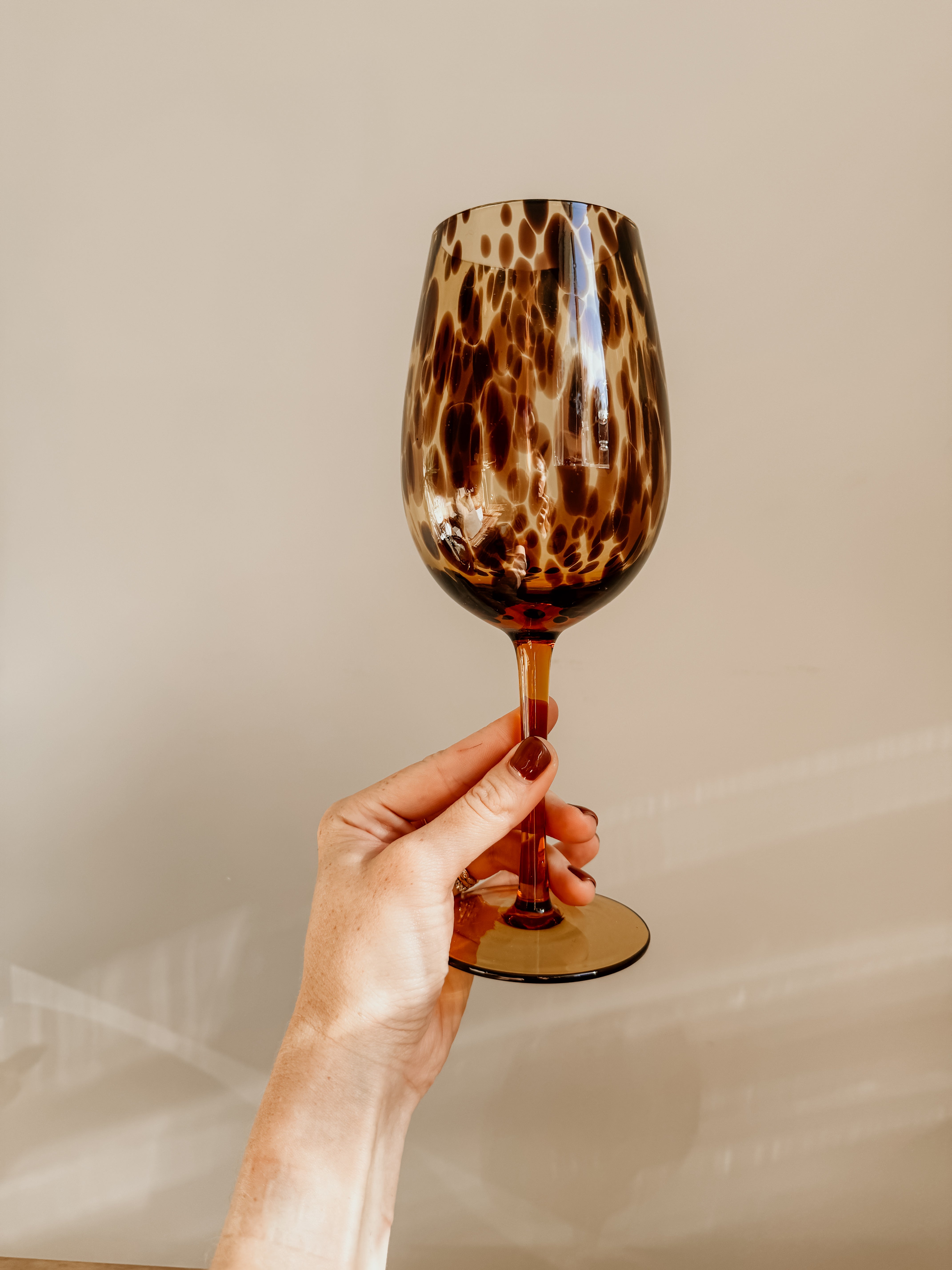 Tortoiseshell wine glass from Tusker Trading with a sleek account design, clear glass bowl and decorative tortoiseshell pattern.