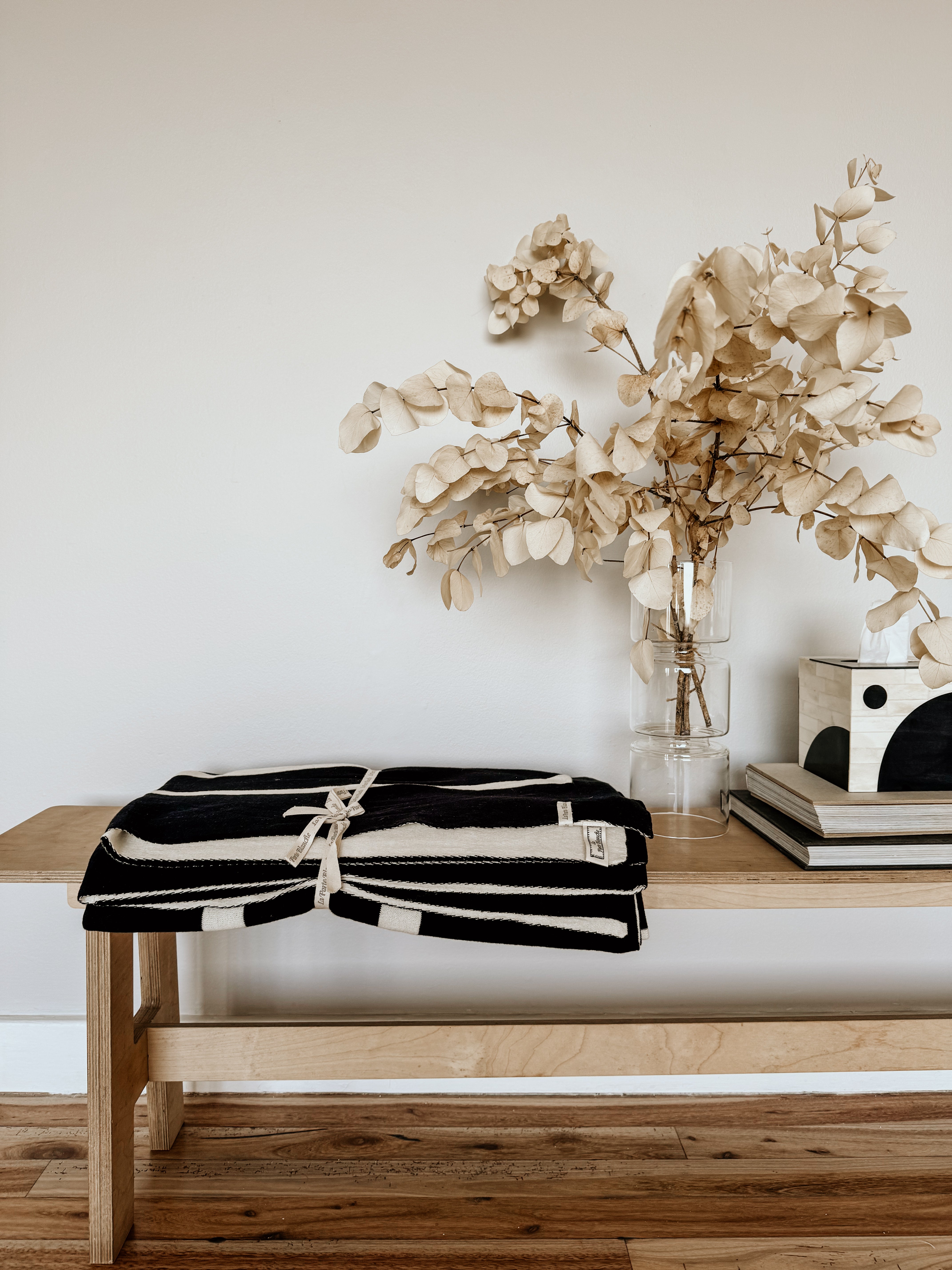 Homestyle Textiles CC black and white linear monochrome throw draped over a sofa, showcasing modern monochrome design.