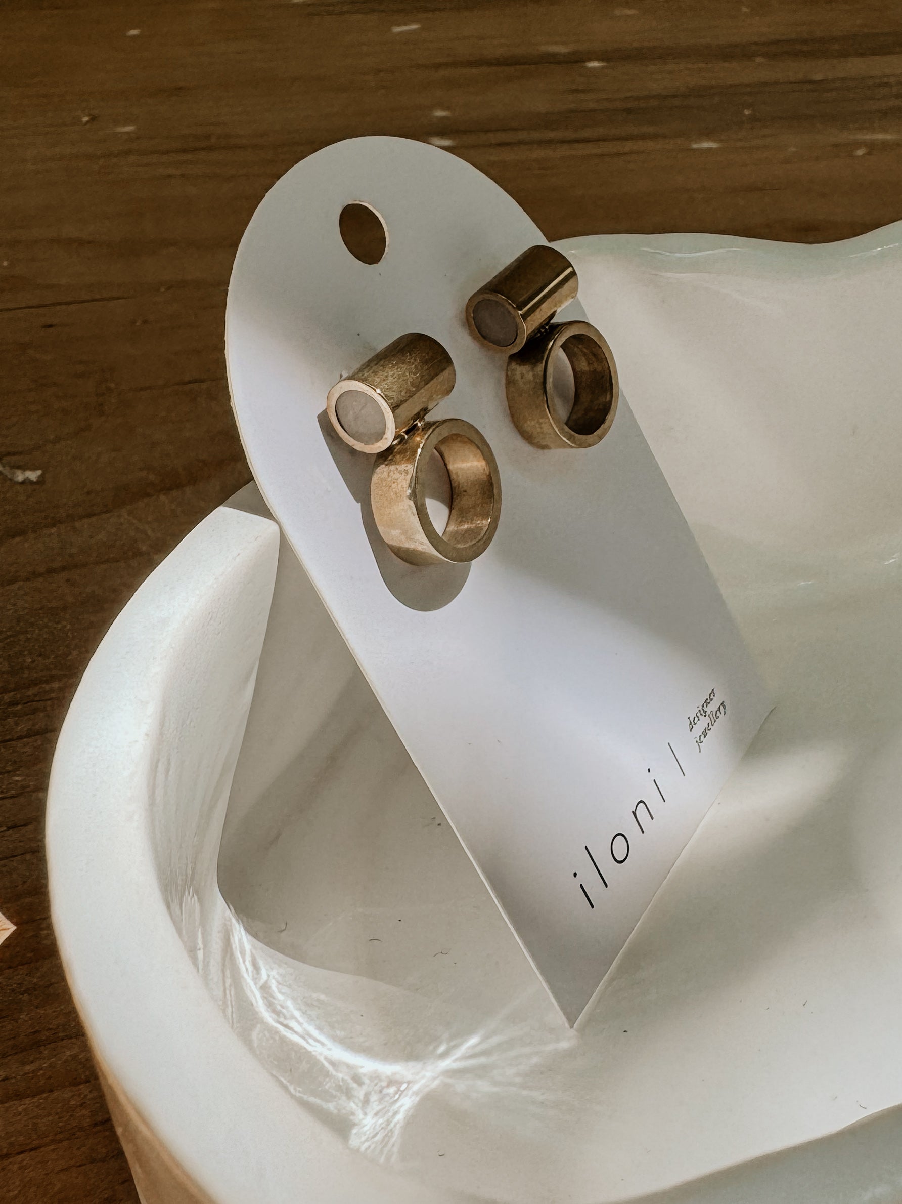 Iloni Designer Jewellery Horizon brass earrings with stone accents, showcasing elegant dangle style and intricate craftsmanship.