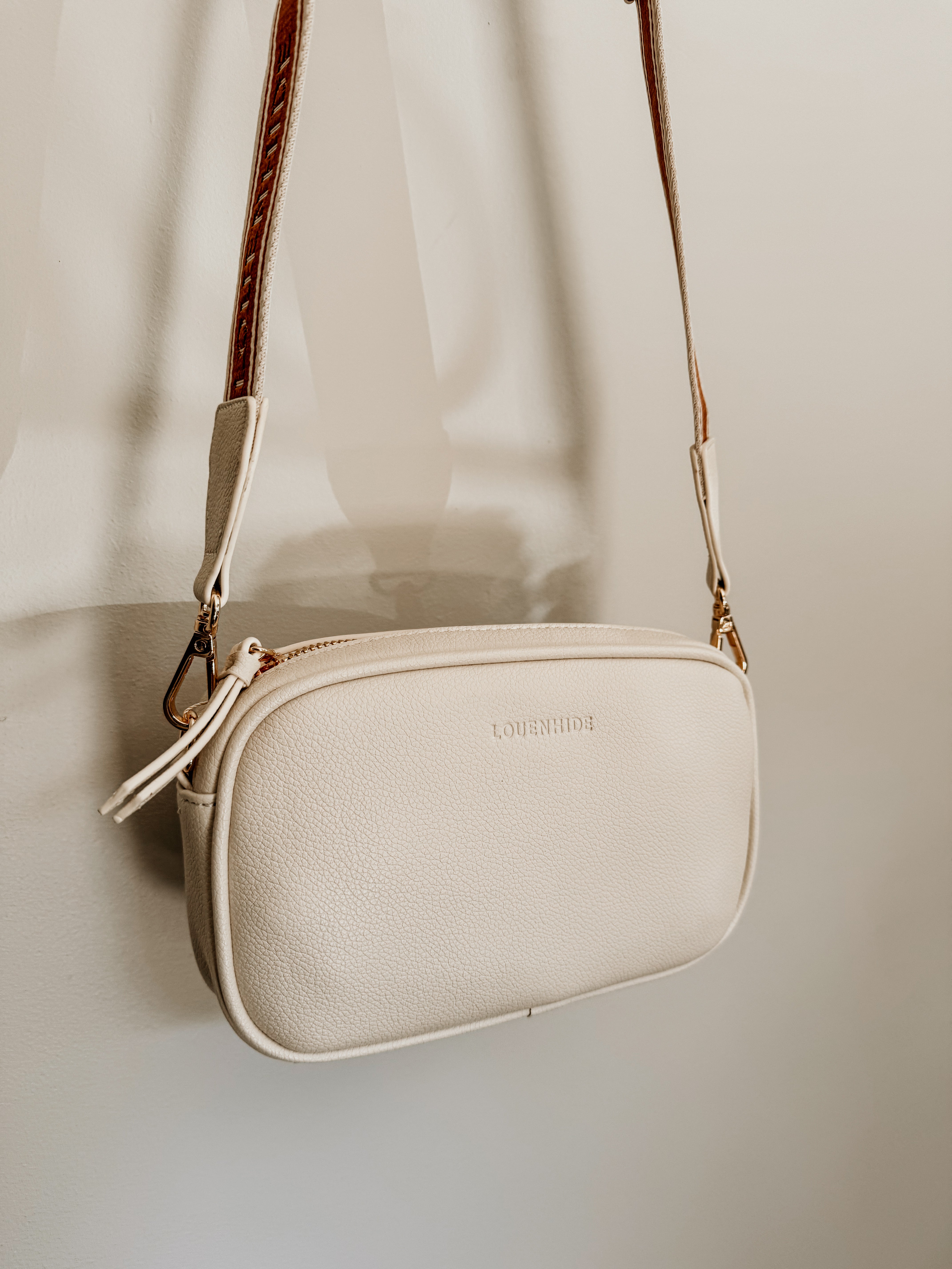 LouenHide Bianca crossbody bag in vanilla leather, with adjustable strap and sleek design, perfect for casual or formal wear.