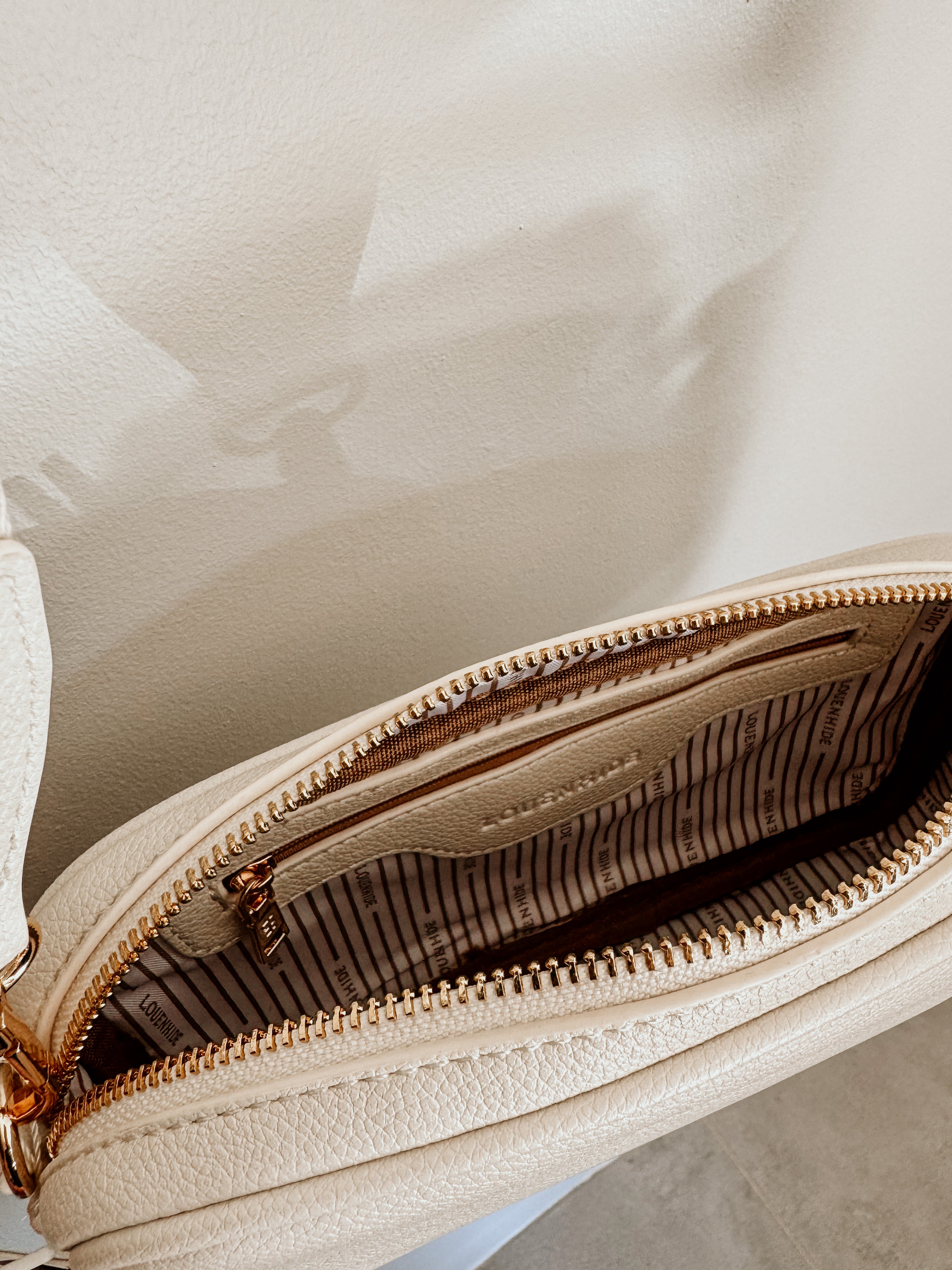 LouenHide Bianca crossbody bag in vanilla leather, stylish accessory with adjustable strap and sleek design.