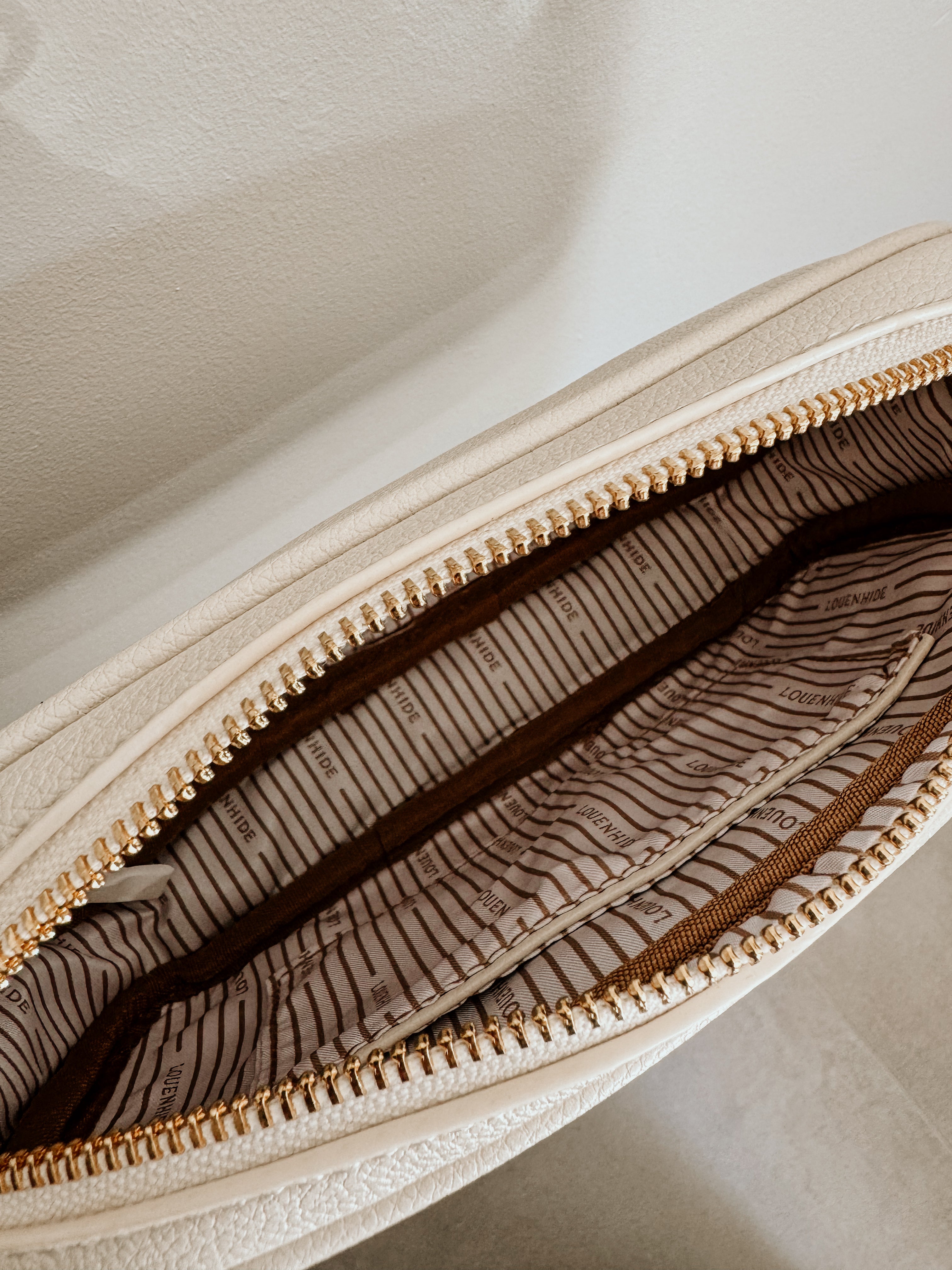 LouenHide Bianca crossbody bag in vanilla leather, stylish and compact with adjustable strap, casual accessory for everyday use.