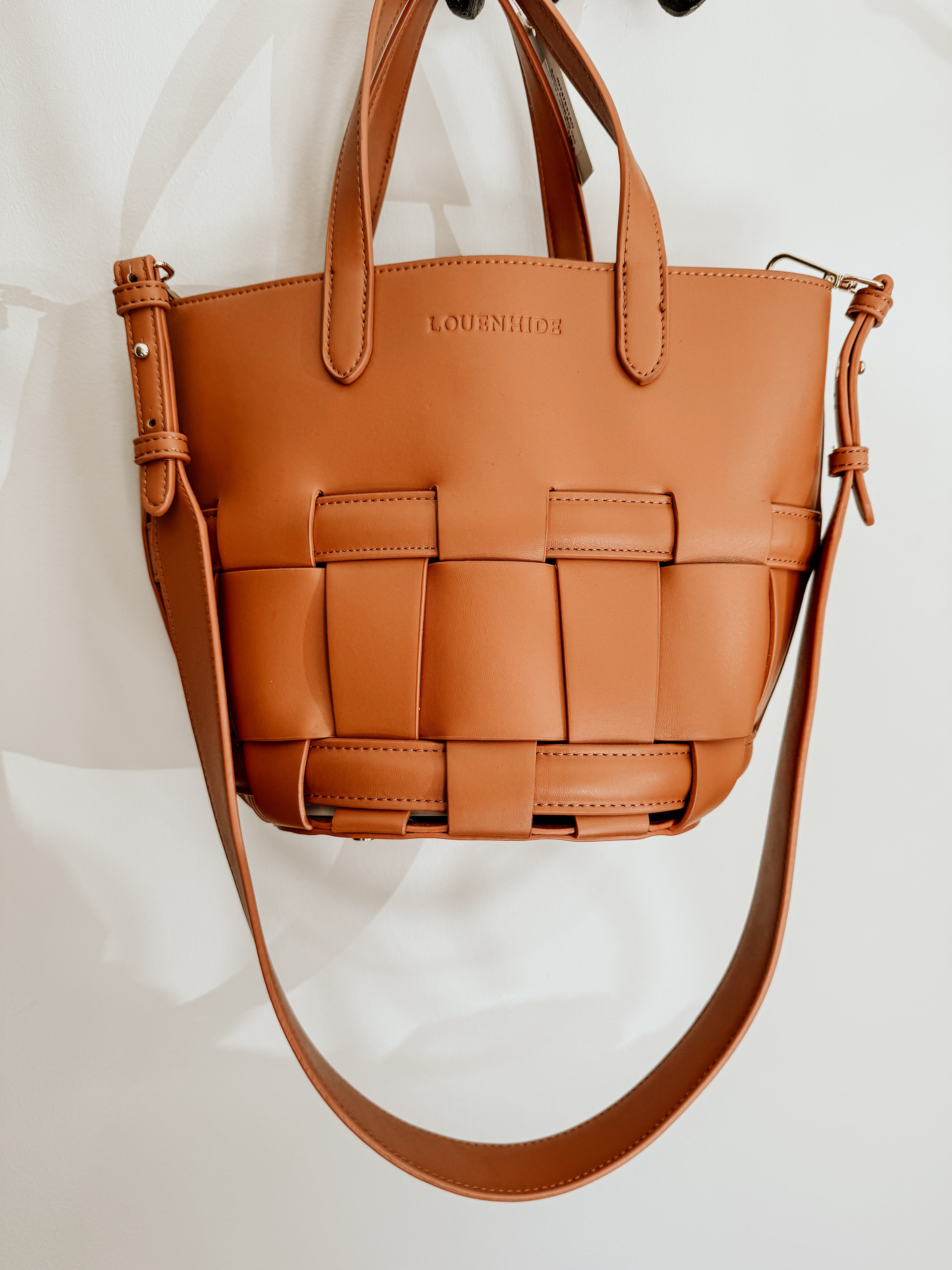 LouenHide Bettina Bucket Bag in tan leather with adjustable strap and spacious interior, shown on a plain background.