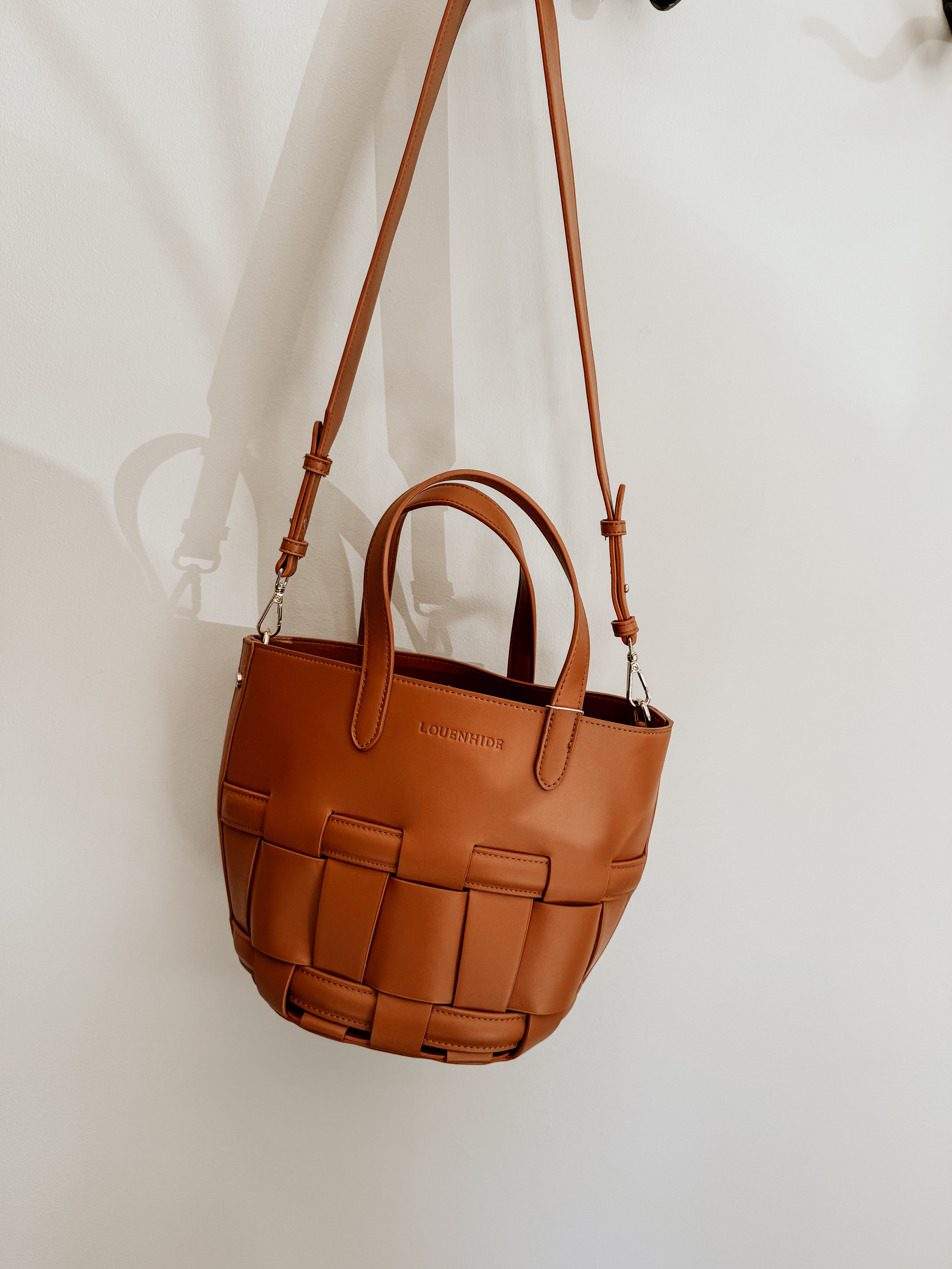 LouenHide Bettina Bucket Bag in tan leather, showcasing its stylish shape and textured finish on a neutral background.