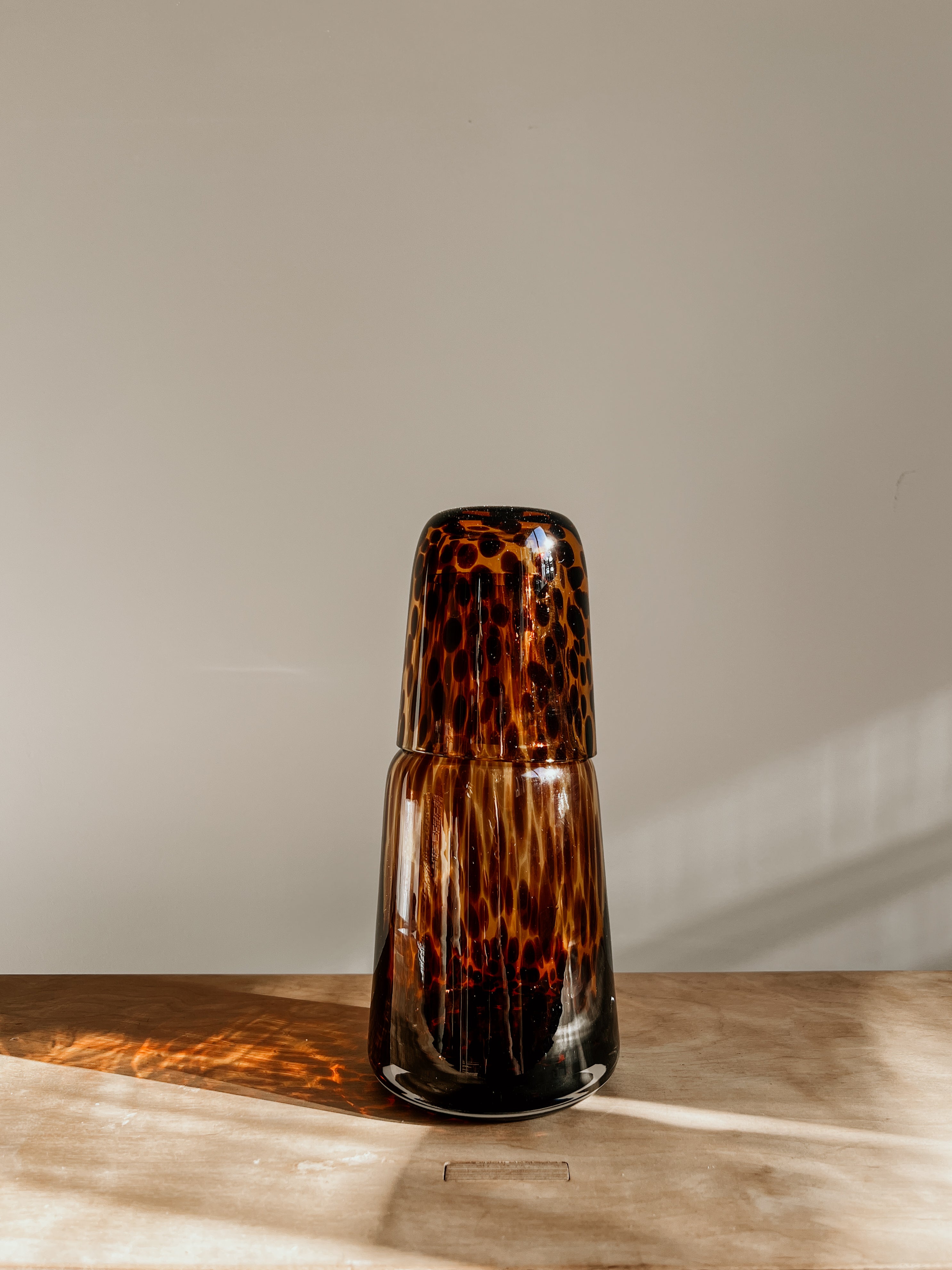 Tortoise shell Carrafe account by Tusker Trading, featuring a stylish tortoise shell design with intricate patterns and glossy finish.
