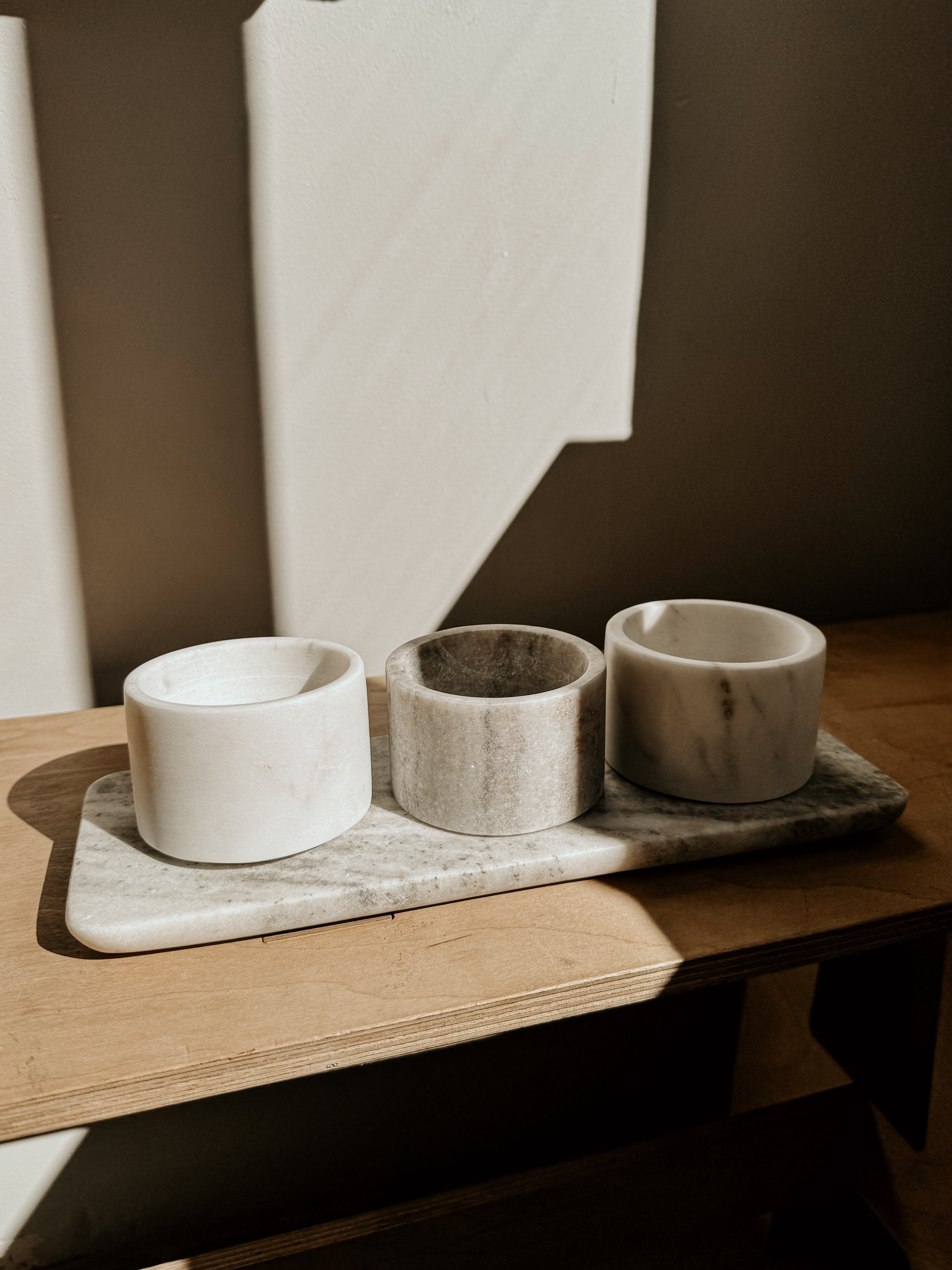 Beige and white marble bowls and tray set from Victoria House Imports, featuring elegant, smooth marble surfaces and modern design.