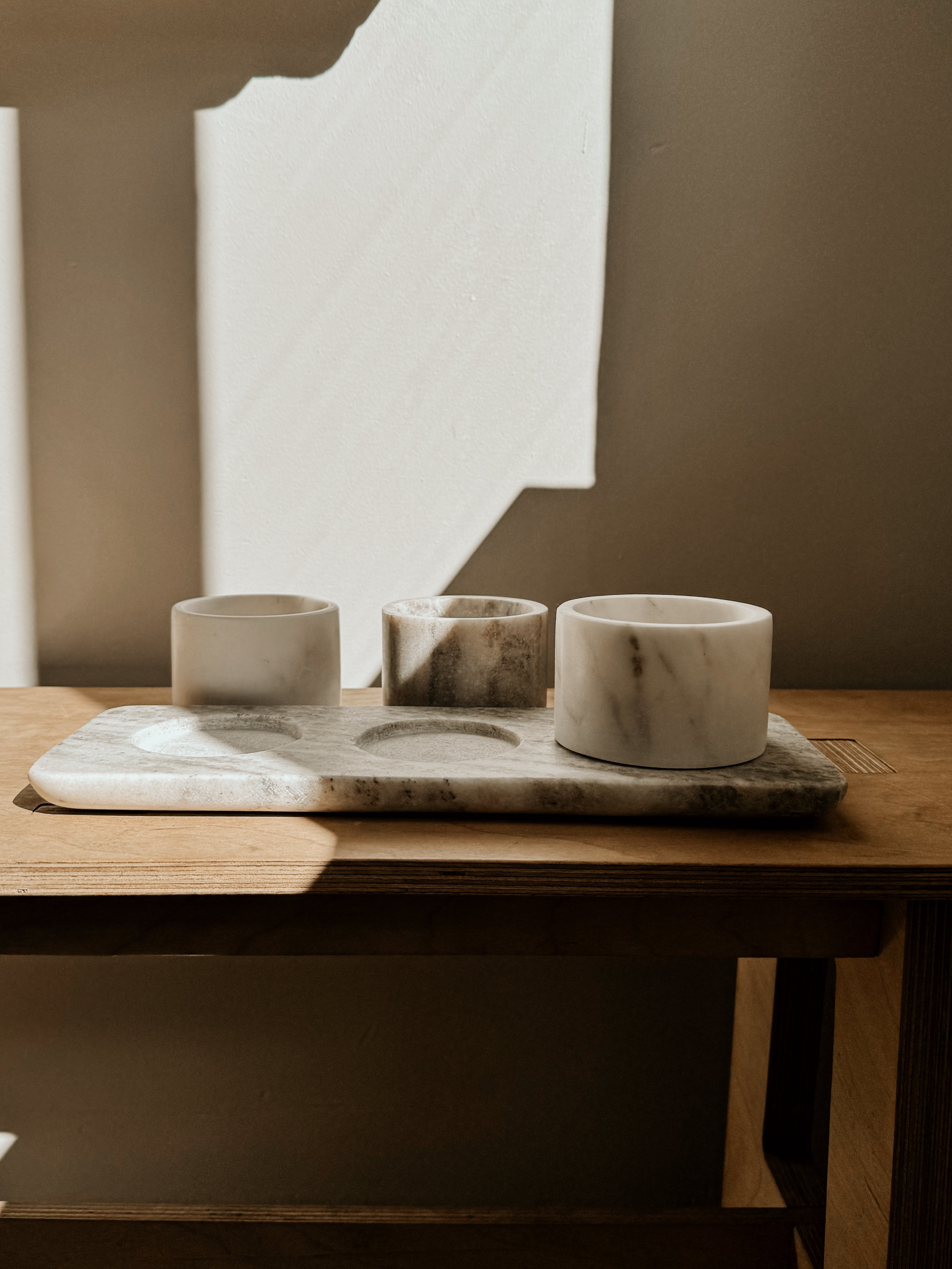 Beige and white marble bowls and tray set by Victoria House Imports, showcasing smooth, polished surfaces and elegant design.