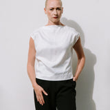 White Drape High Neck Top by Lika Designs, stylish consignment fashion, close-up of the elegant high neckline and draped fabric.