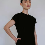 Black linen blend midi dress by Lika Designs, shown on model, featuring a flowy silhouette and elegant design.