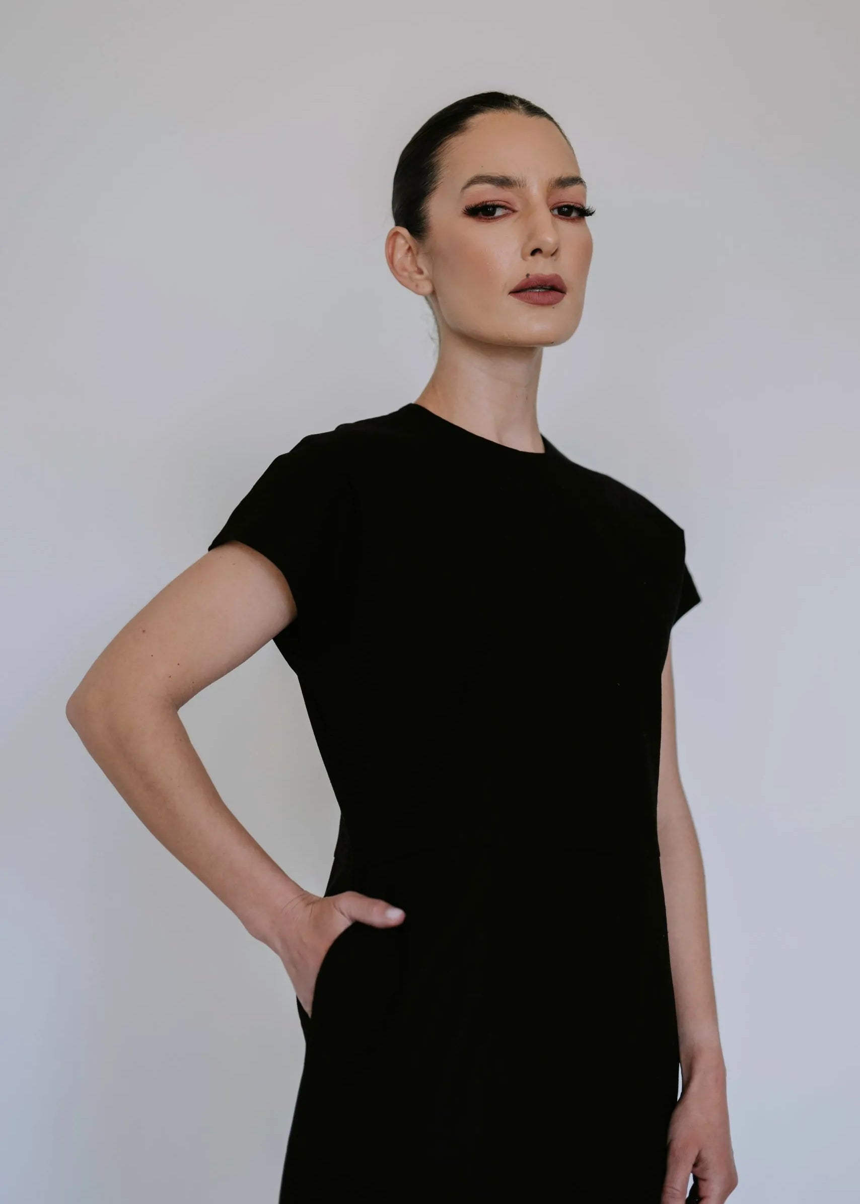 Black linen blend midi dress by Lika Designs, shown on model, featuring a flowy silhouette and elegant design.